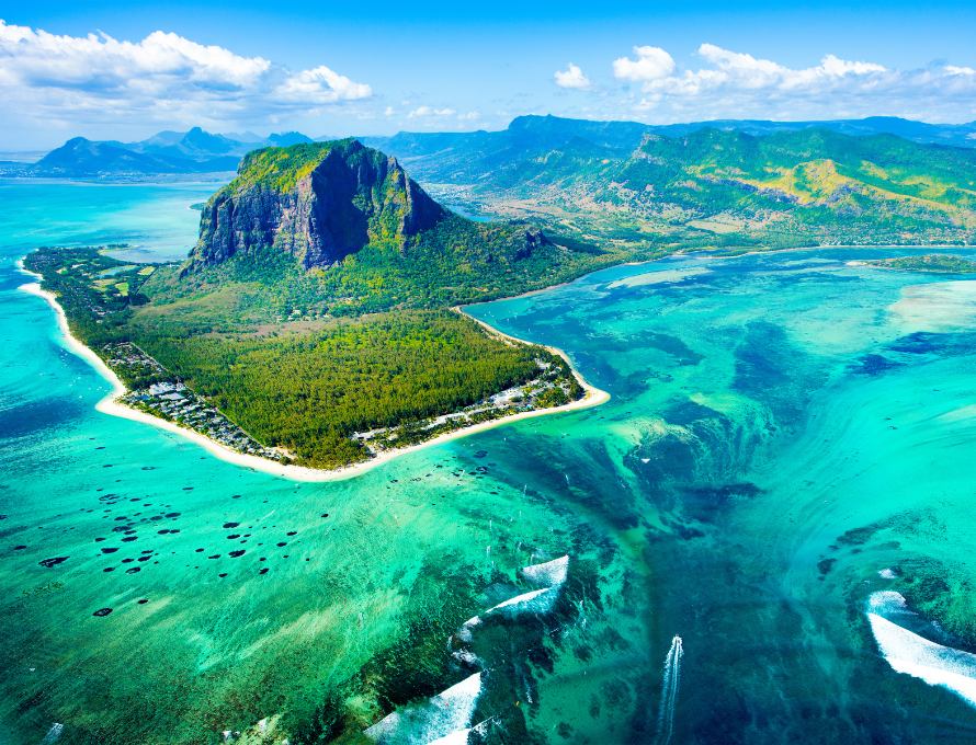 Aerial view of Kauai coastline and green mountains in Hawaii
