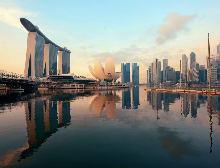 Marina Bay Sands and Singapore skyline reflected in the water at sunset