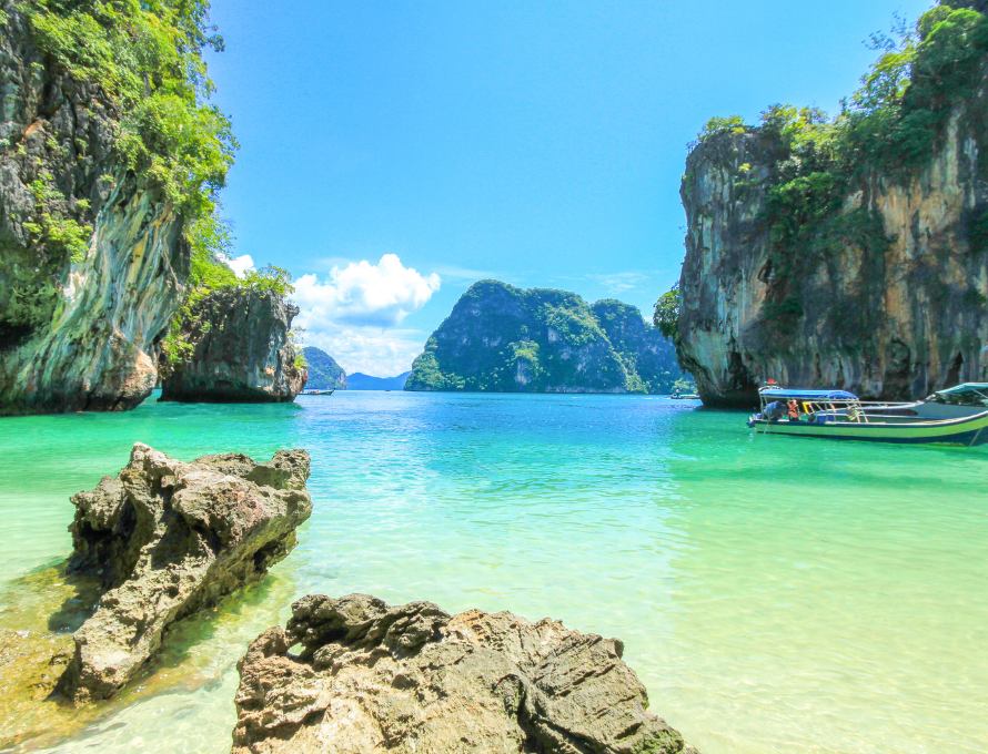 Limestone cliffs and turquoise water at a tropical beach in Thailand