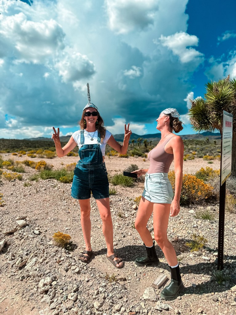 Car and Cara standing in Area 51, in Nevada USA wearing tin foil hats to deter the aliens from reading our minds. 