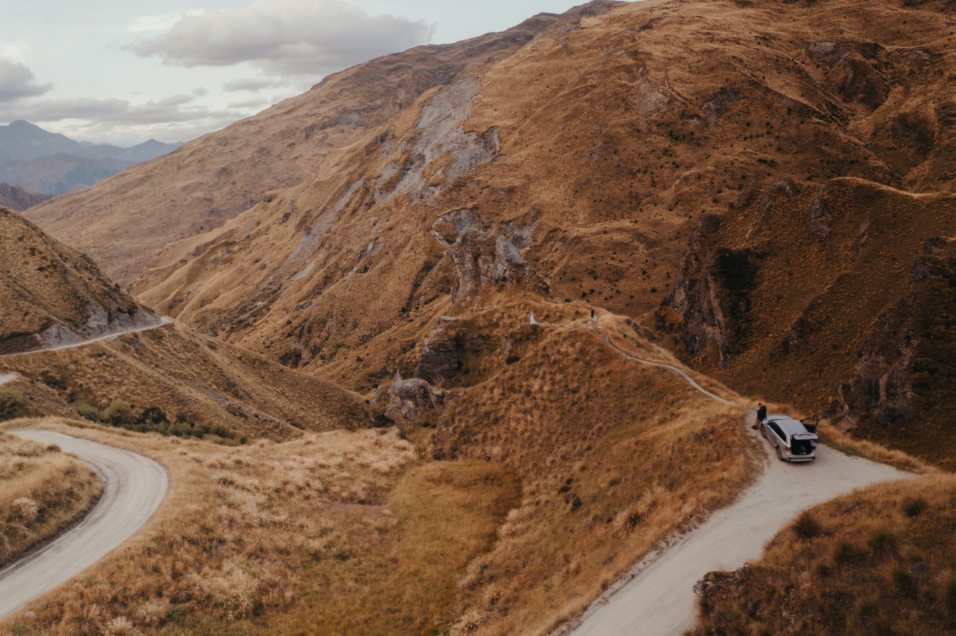 Scenic mountain road through golden hills in New Zealand