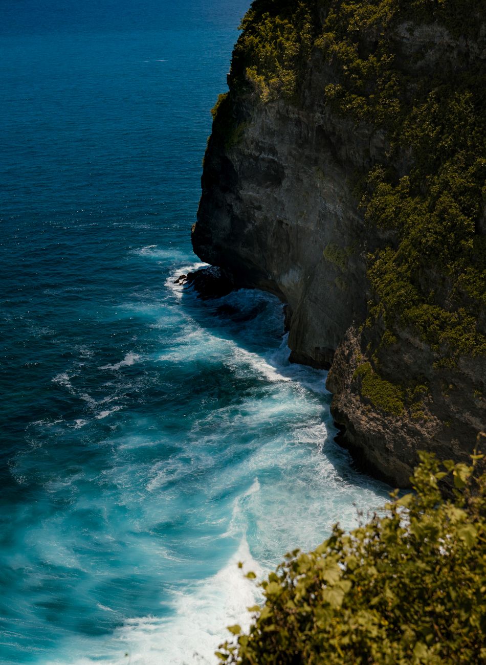 Dramatic limestone cliffs and blue ocean on the Uluwatu coastline in Bali