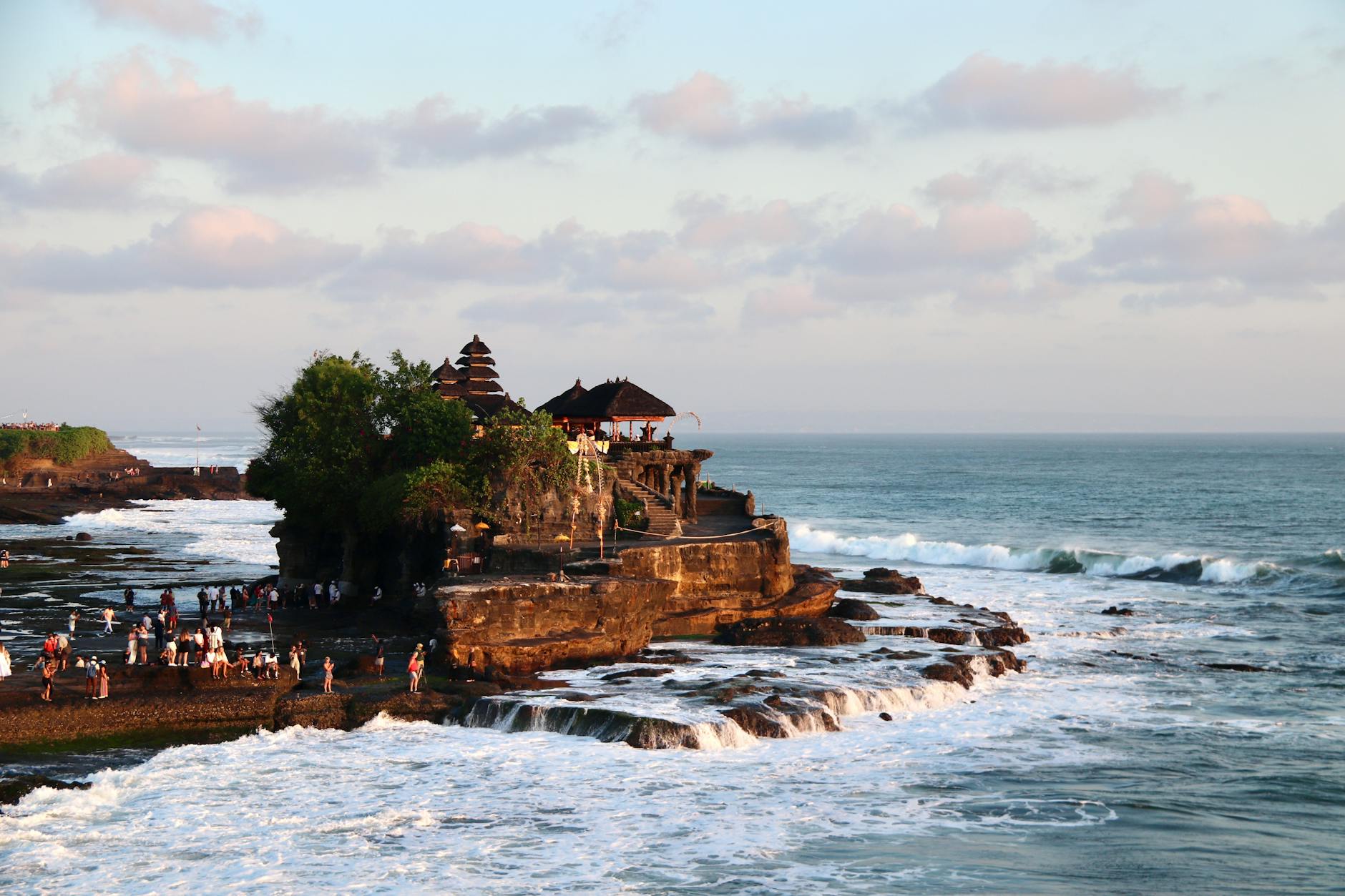 Tanah Lot Temple on the ocean rocks at sunset near Canggu, Bali