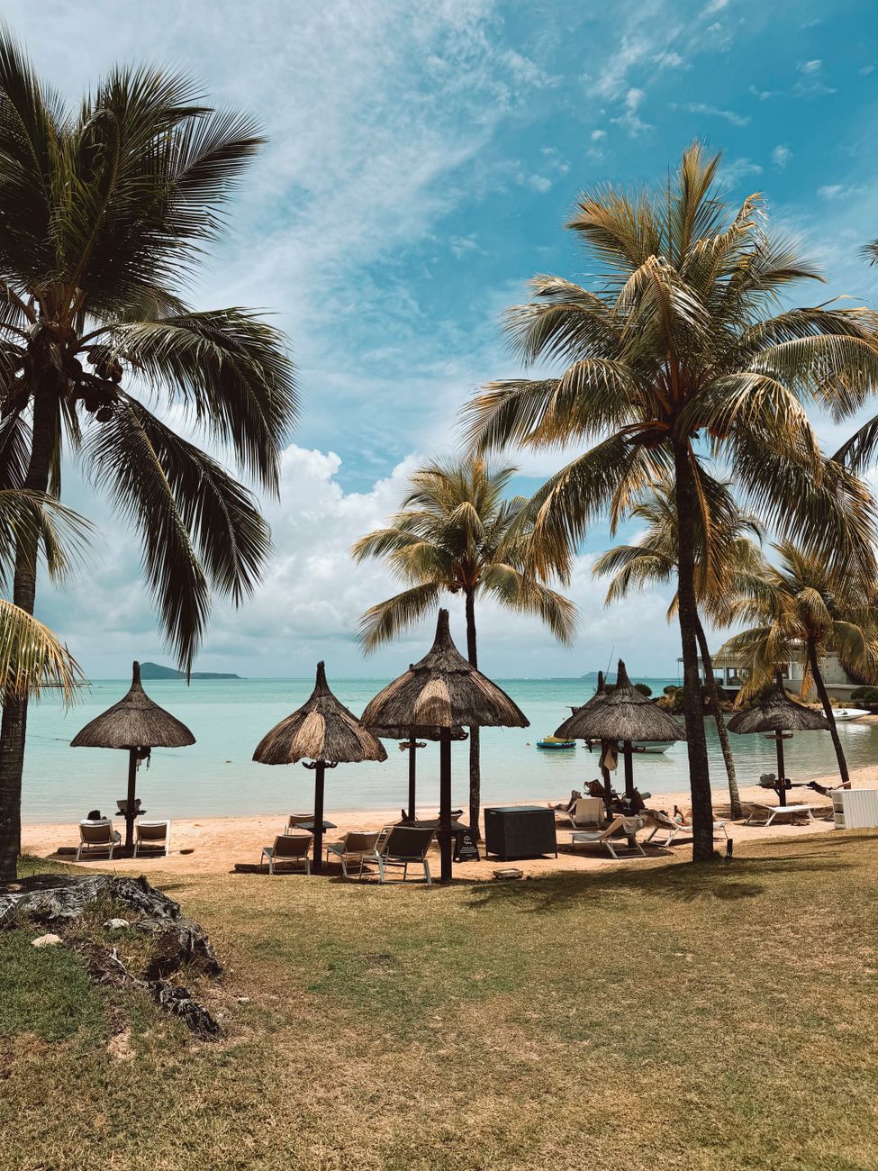 Tropical beach with palm trees and lagoon in Mauritius. Hotel Lux le Grand Gaube