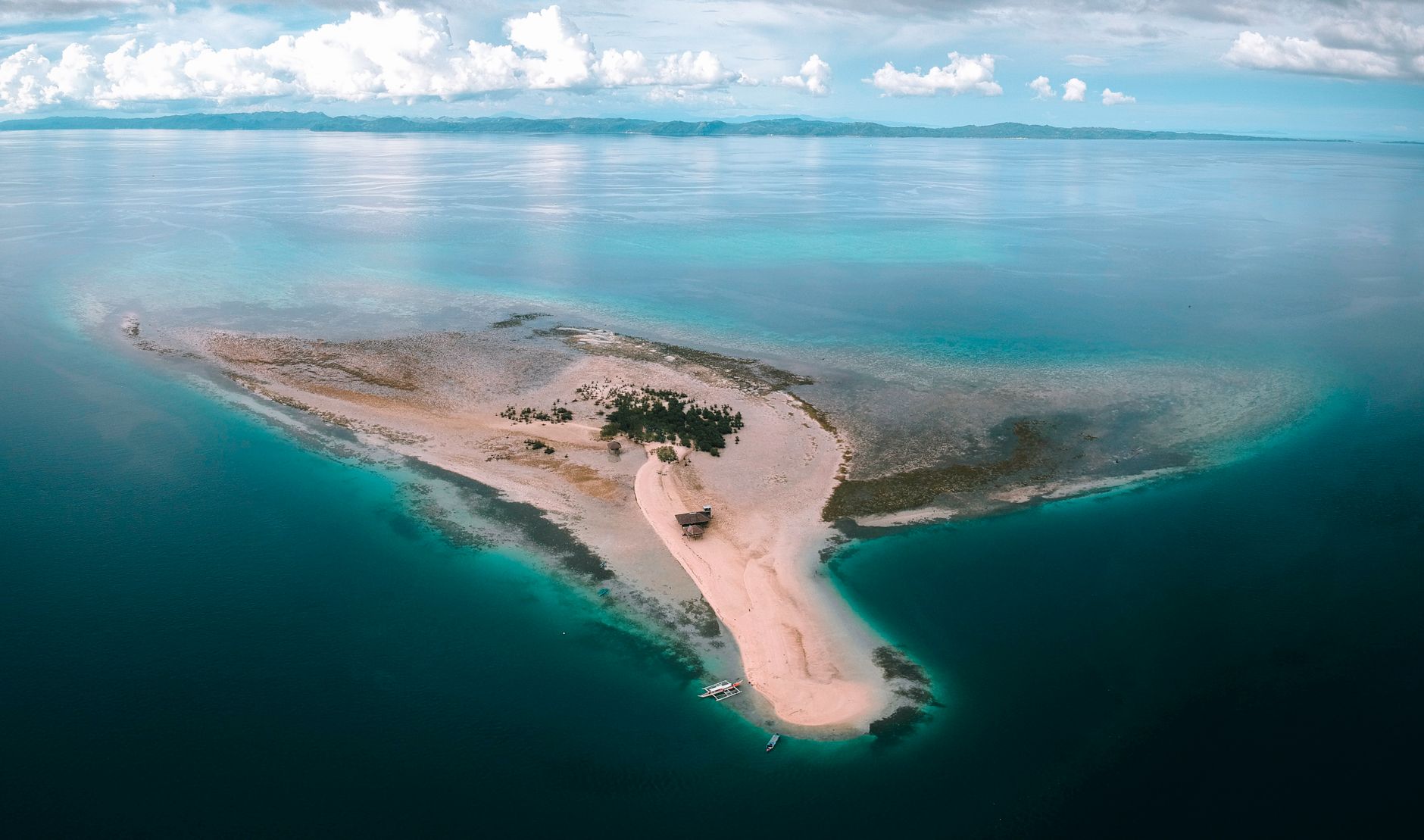 Aerial view of a tropical sandbar and turquoise water in the Philippines
