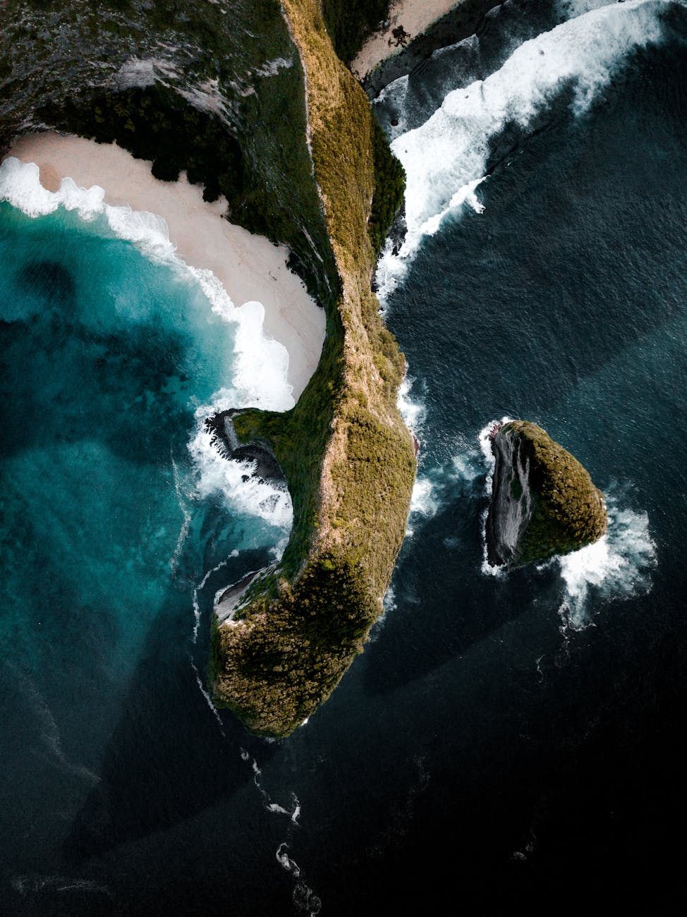 Aerial view of cliffs, white sand, and turquoise water near Nusa Lembongan