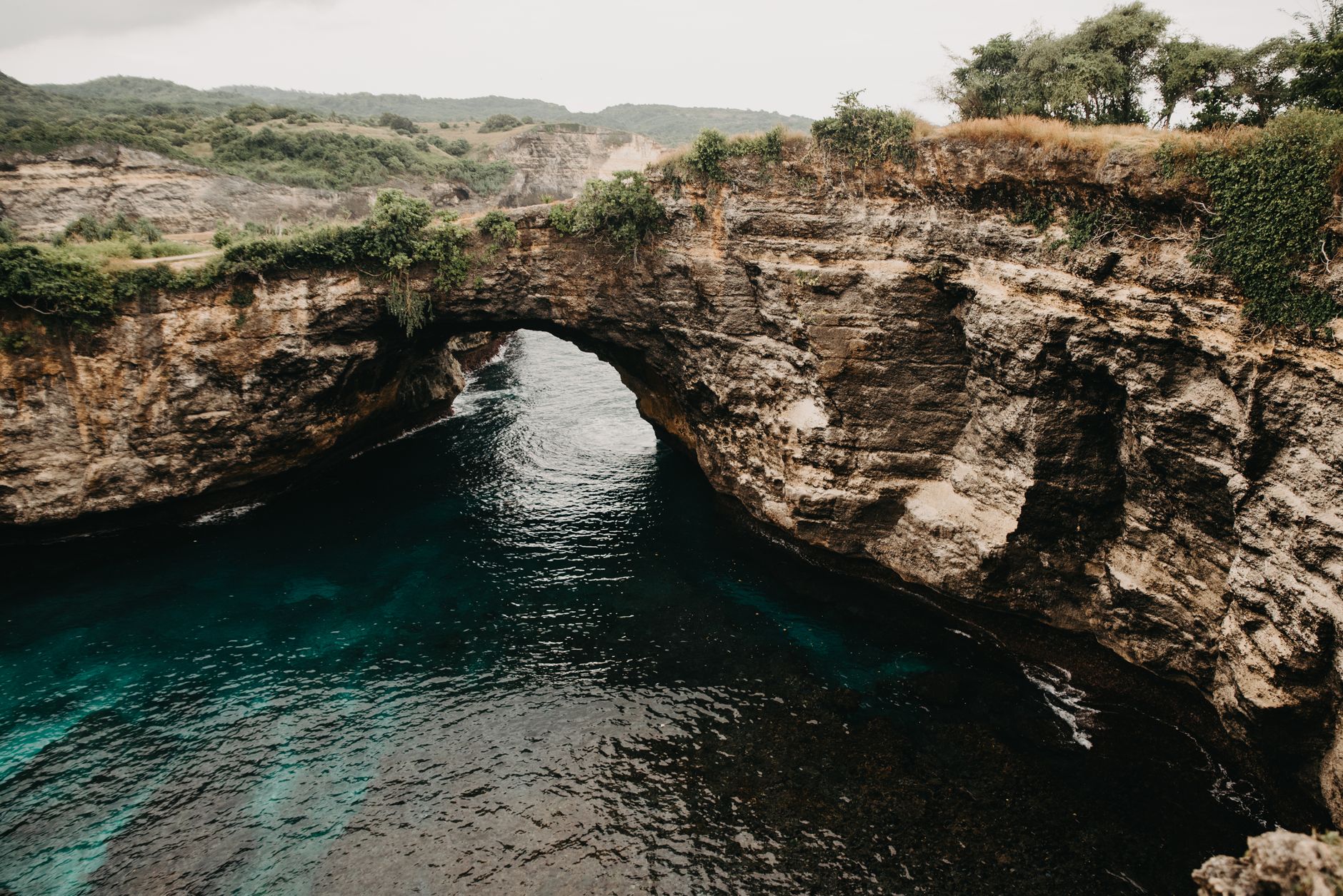 Natural rock arch and blue ocean at Broken Beach in Nusa Penida