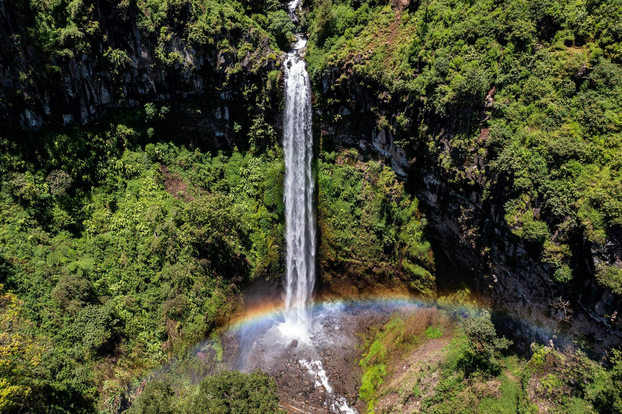 Coban Rondo waterfll with a rainbow. 
