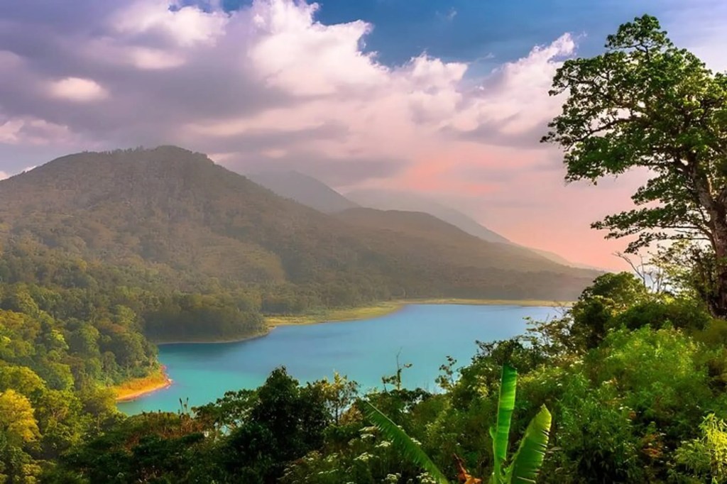 Mountain lake view near Munduk with forest and sunset light