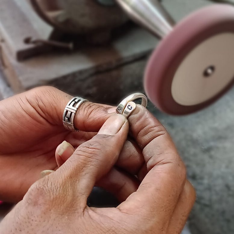 Silver ring being polished during a jewelry workshop in Seminyak, Bali