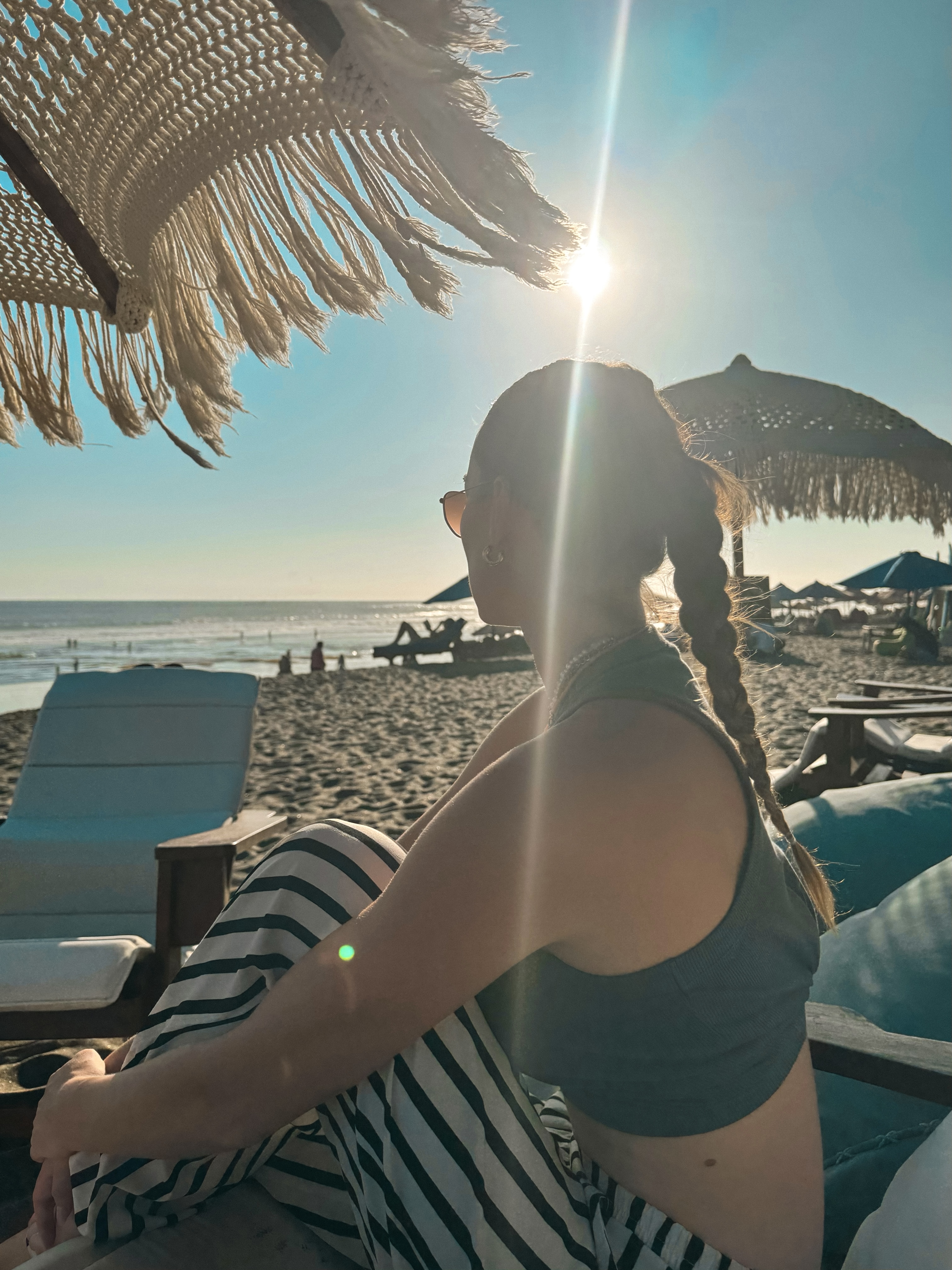 Canggu beach in Bali with sunset light, beach loungers, and ocean views