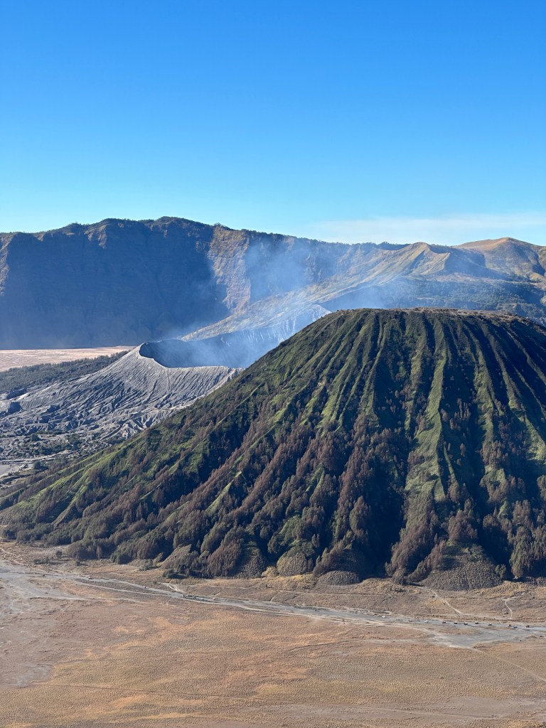 Mount Bromo crater and surrounding volcanic caldera after sunrise
