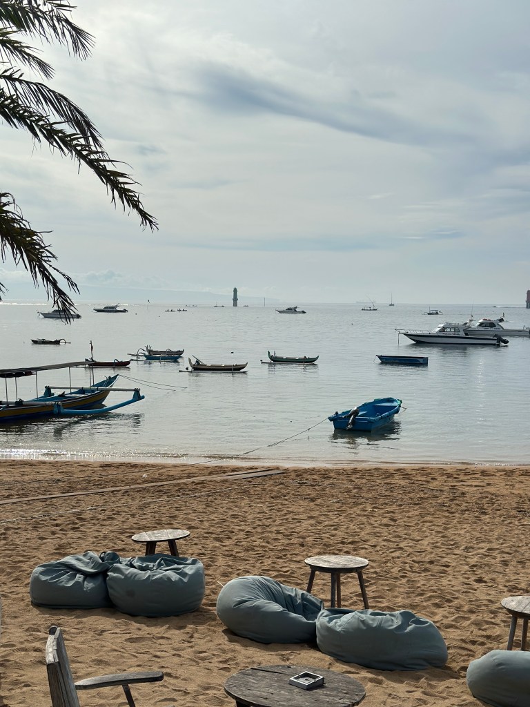 Fishing boats on the calm coastline of Sanur Beach in Bali