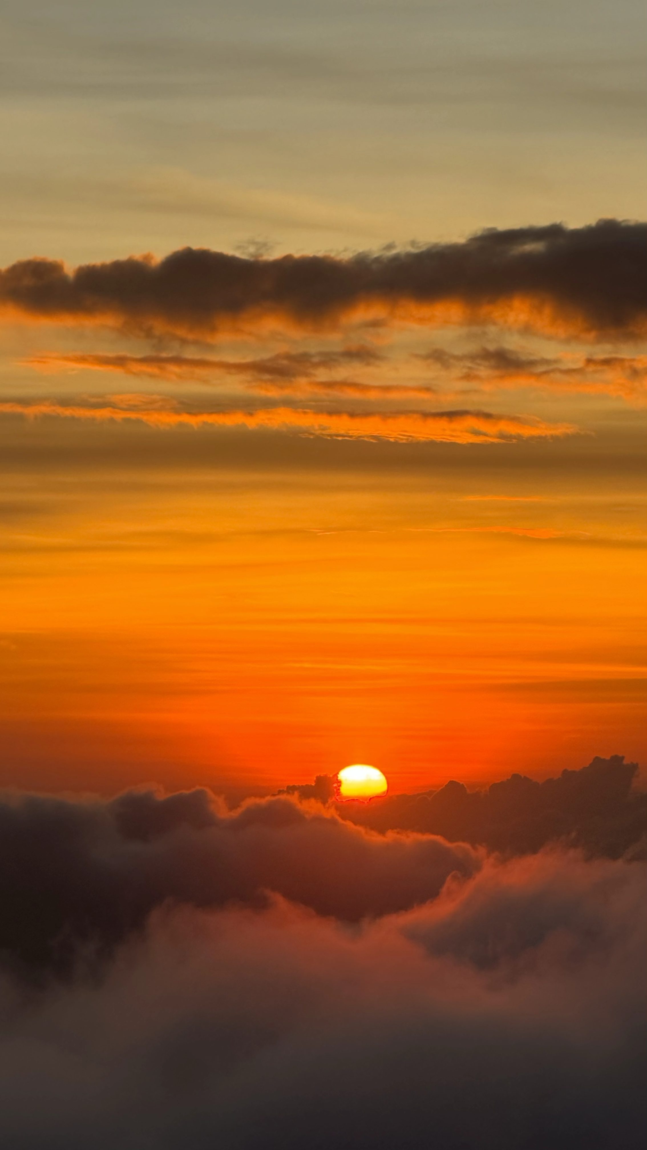 Orange sunrise above the clouds from Mount Batur Bali
