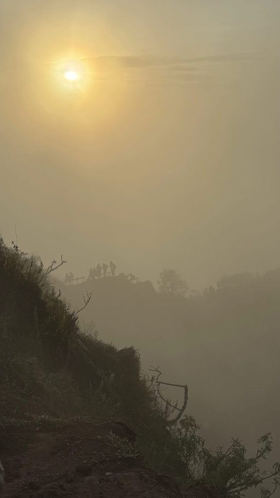 Hazy Mount Batur summit ridge during sunrise hike
