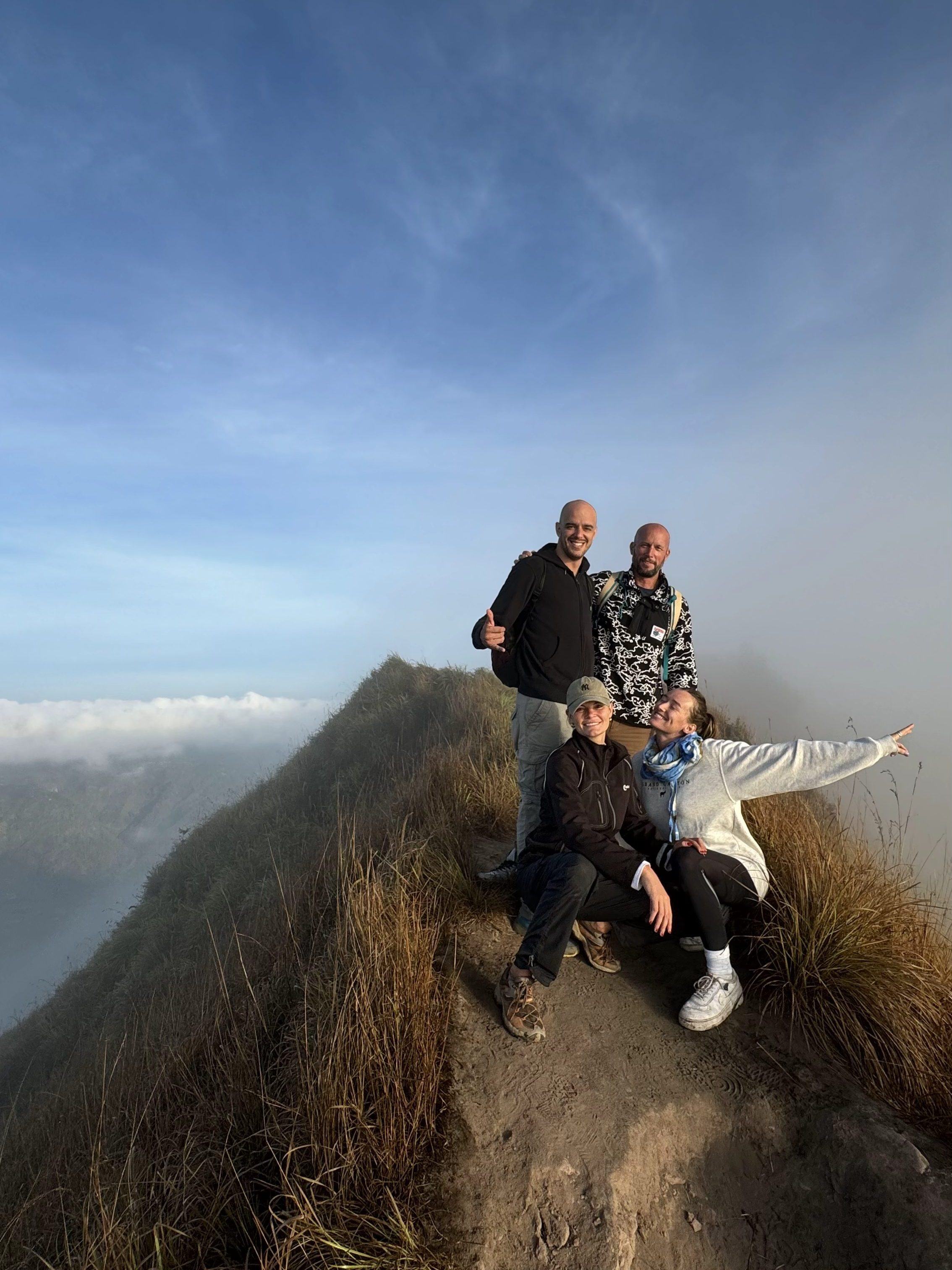 Hikers at the summit of Mount Batur after sunrise in Bali