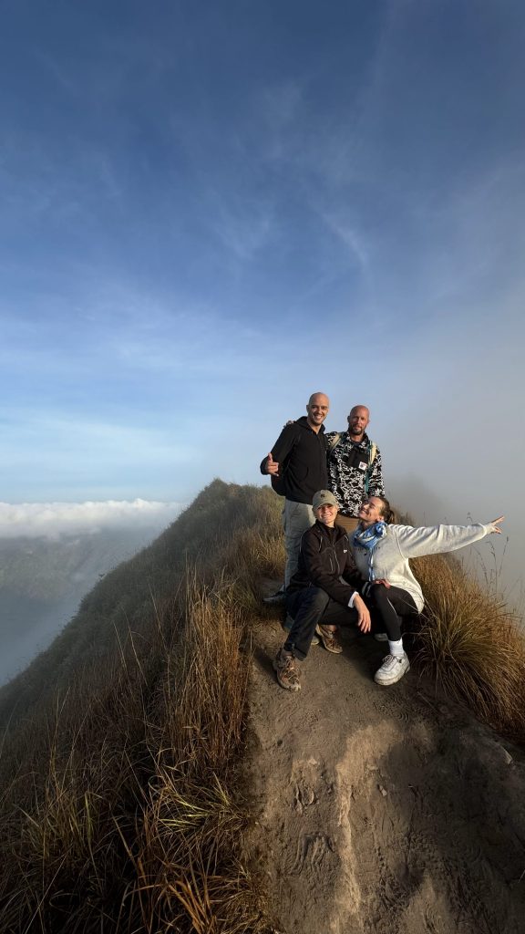 Hikers at the summit of Mount Batur during sunrise in Bali