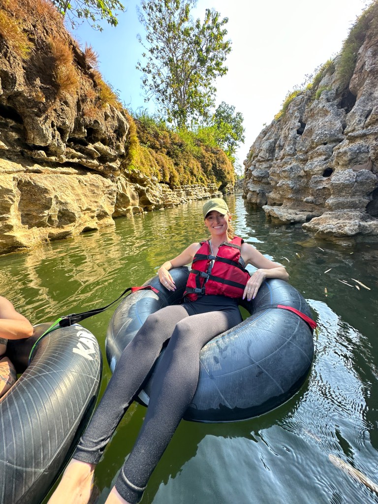 Tubing through a rocky river canyon near Jomblang Cave in Java, Indonesia.
