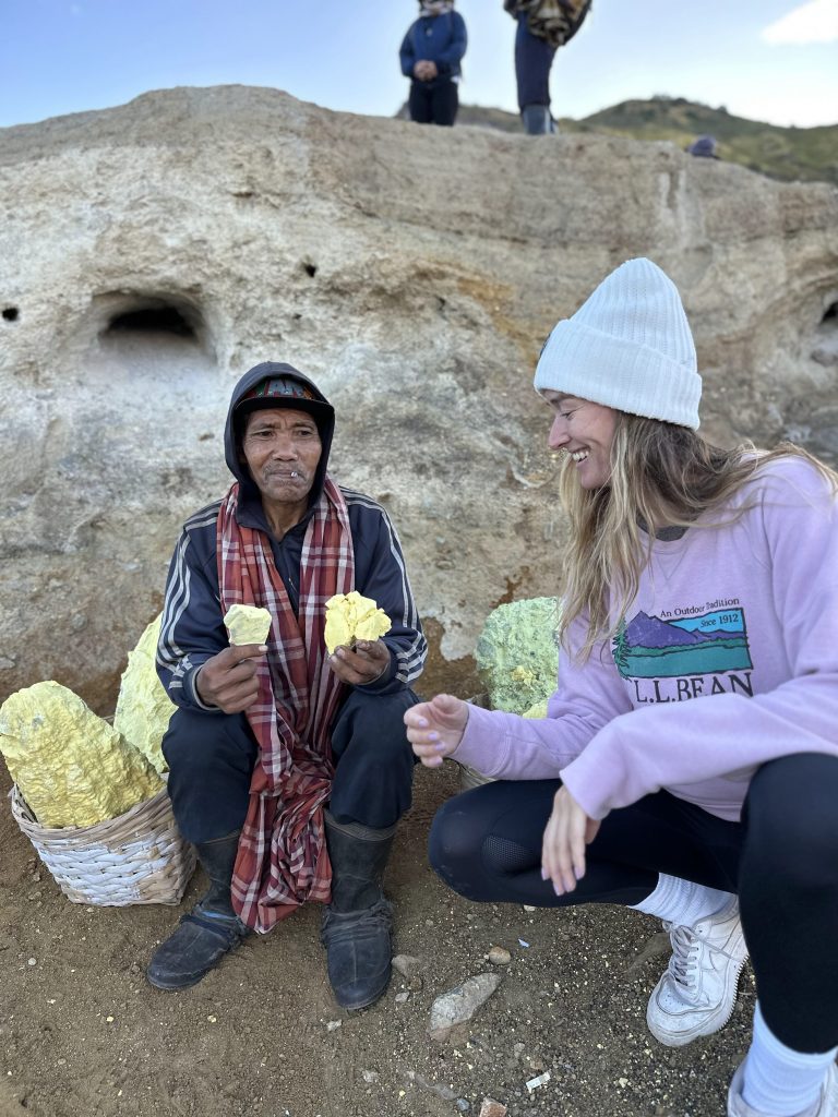 Traveler talking with a sulfur miner at Kawah Ijen in East Java
