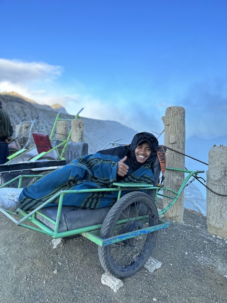Sulfur miner resting in a cart near Kawah Ijen crater
