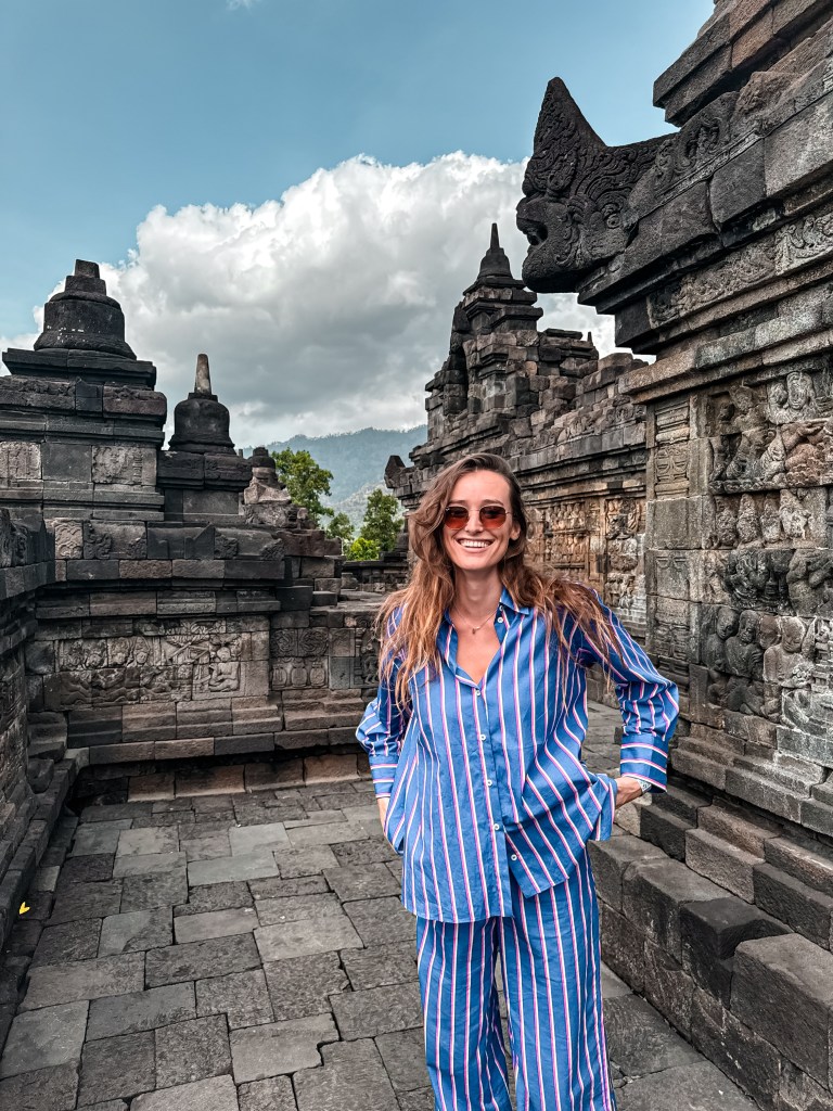 Carlijn standing between stone stupas at Borobudur Temple in Indonesia