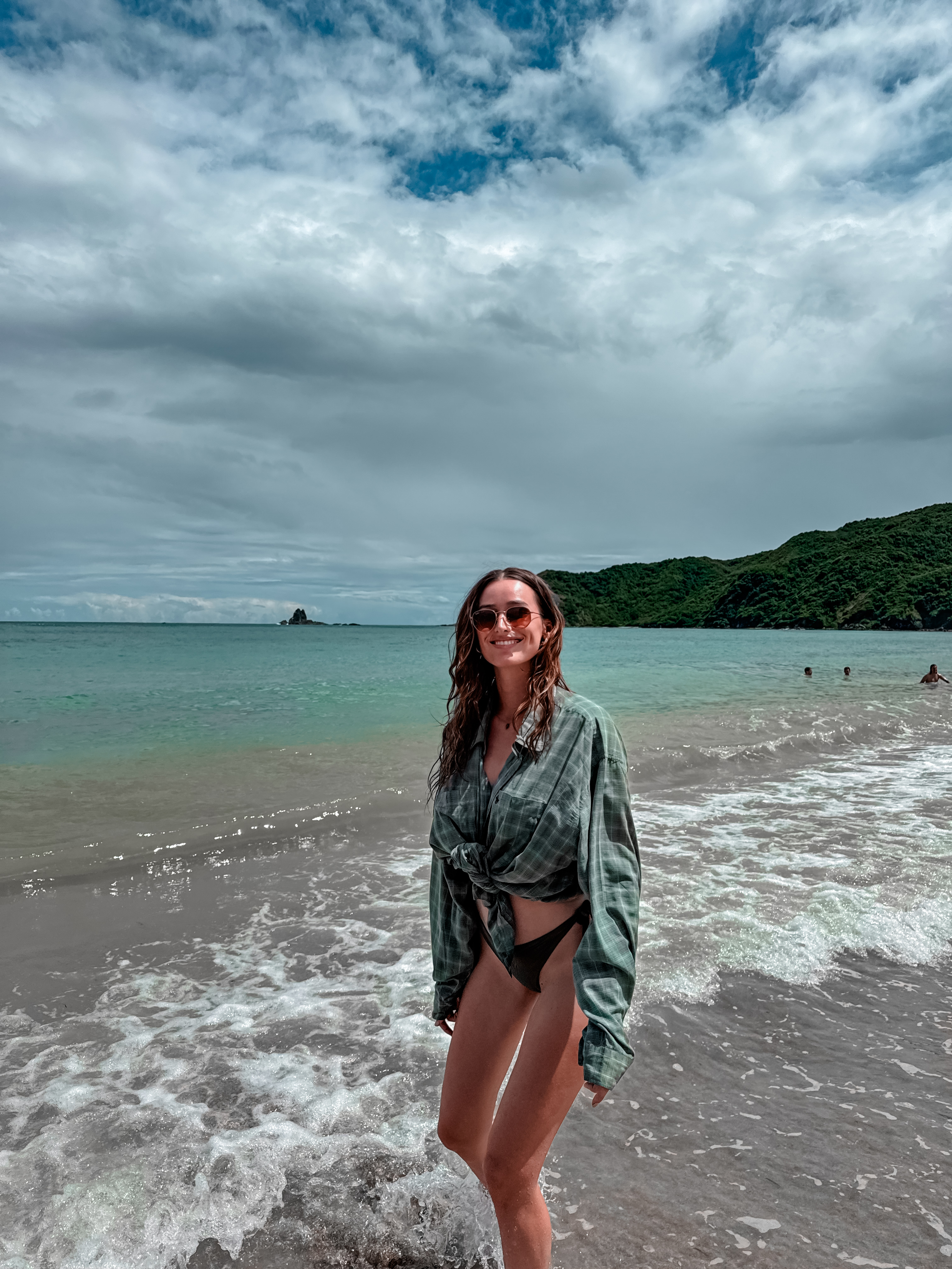 Sandy beach in Lombok with turquoise water and green coastal hills
