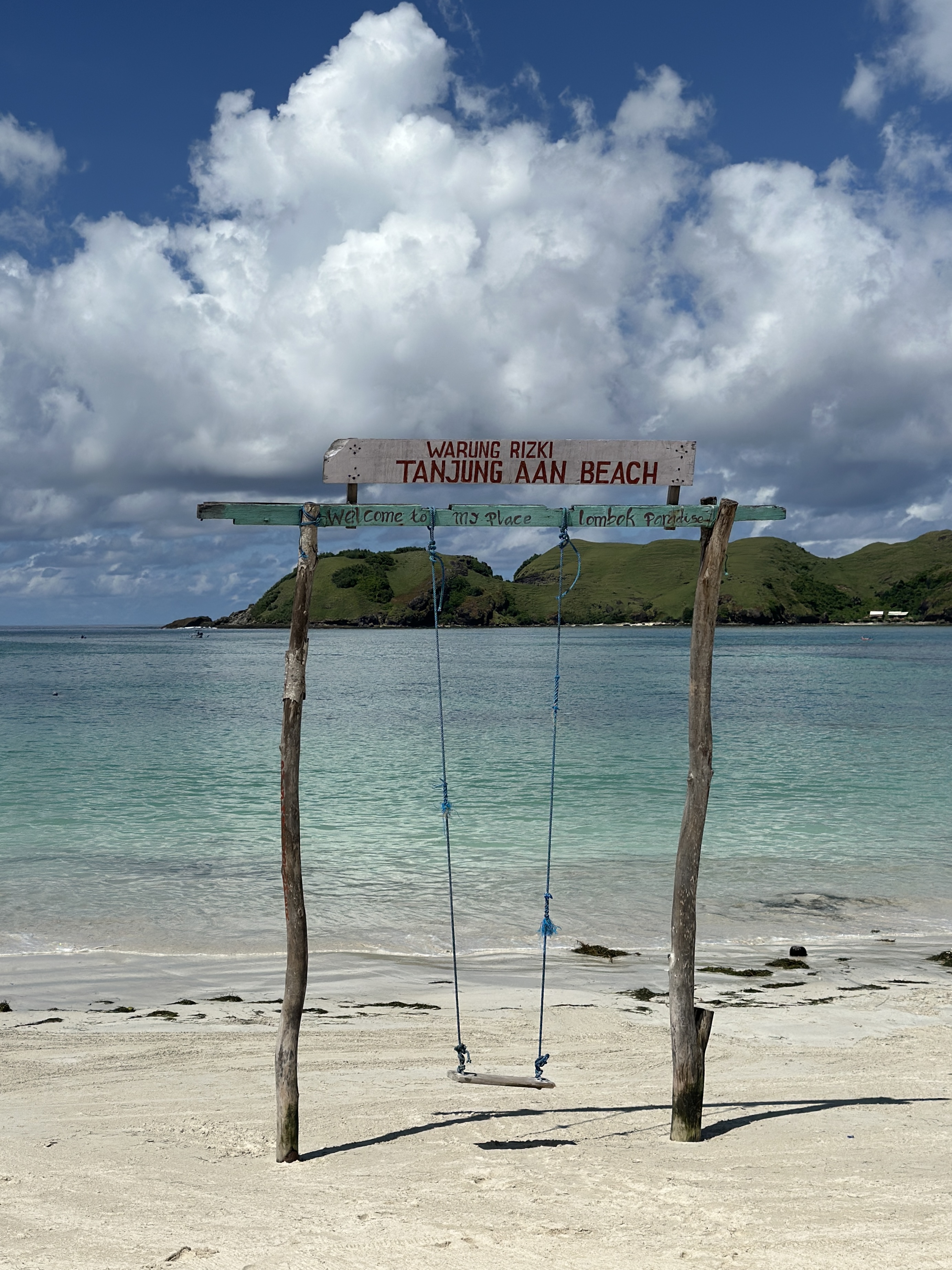 Tanjung Aan Beach in Lombok with turquoise water, white sand, and a beach swing