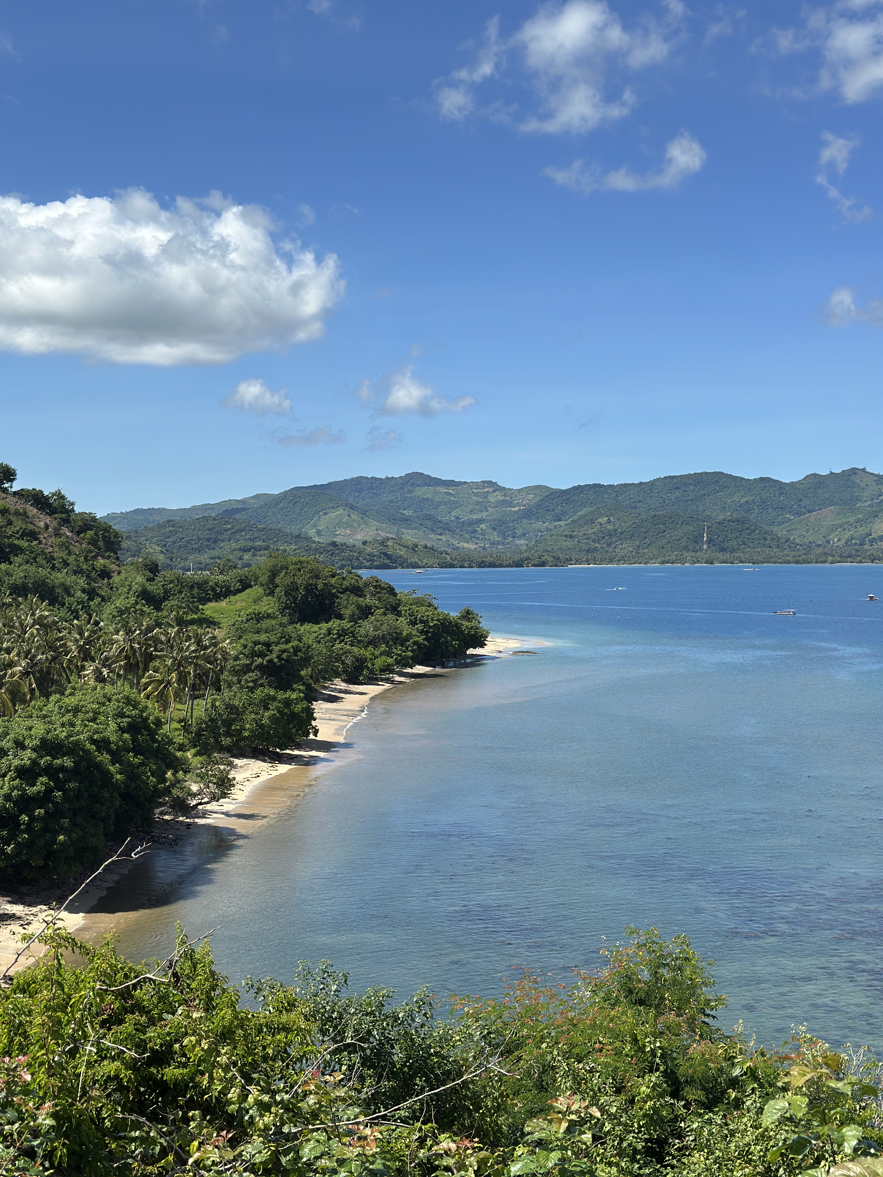Viewpoint over Gili Asahan with turquoise bays, green hills, and the southwest Lombok coastline