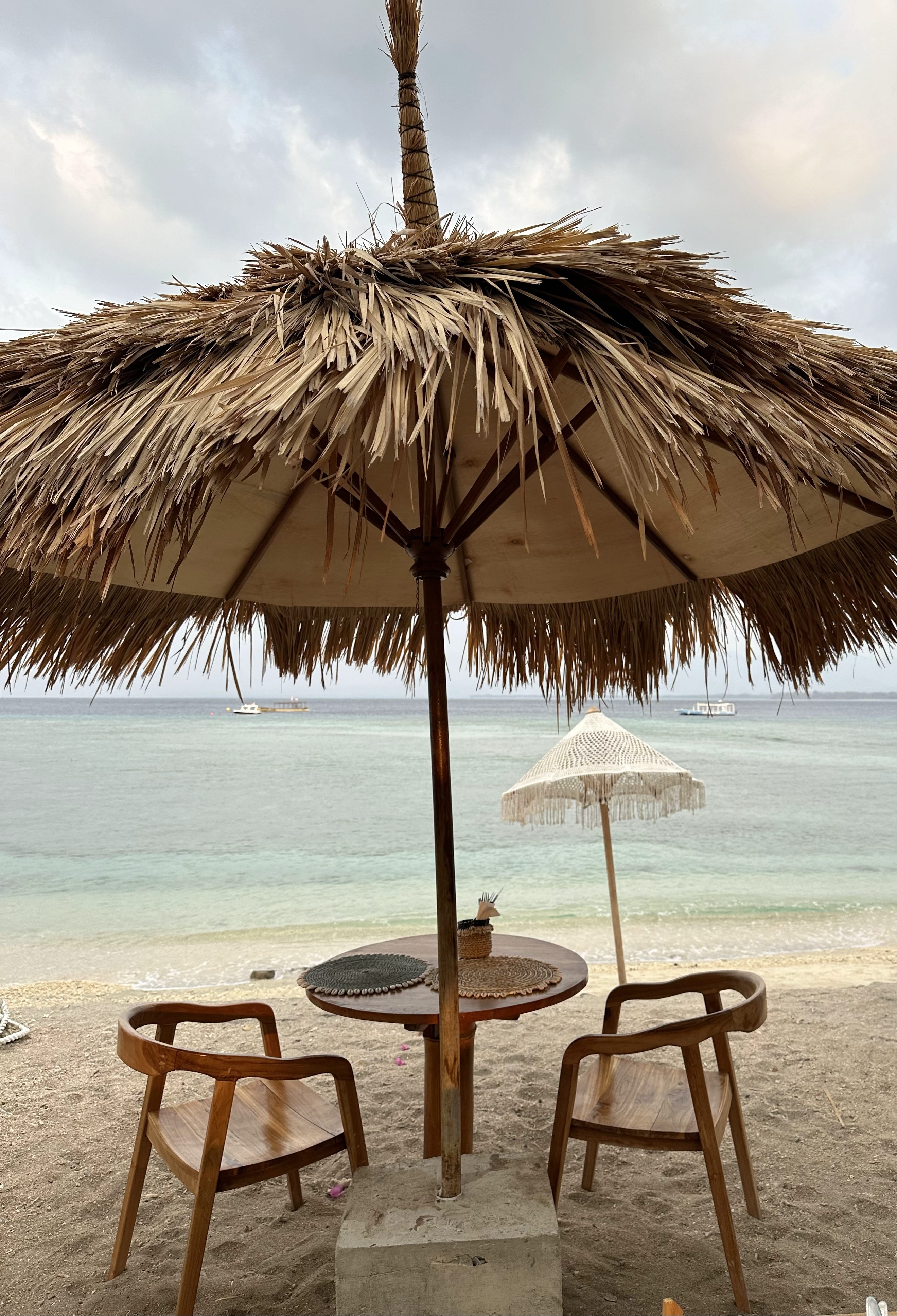 Beach umbrella and chairs on Gili Air, a car-free island known for cycling and slow island life