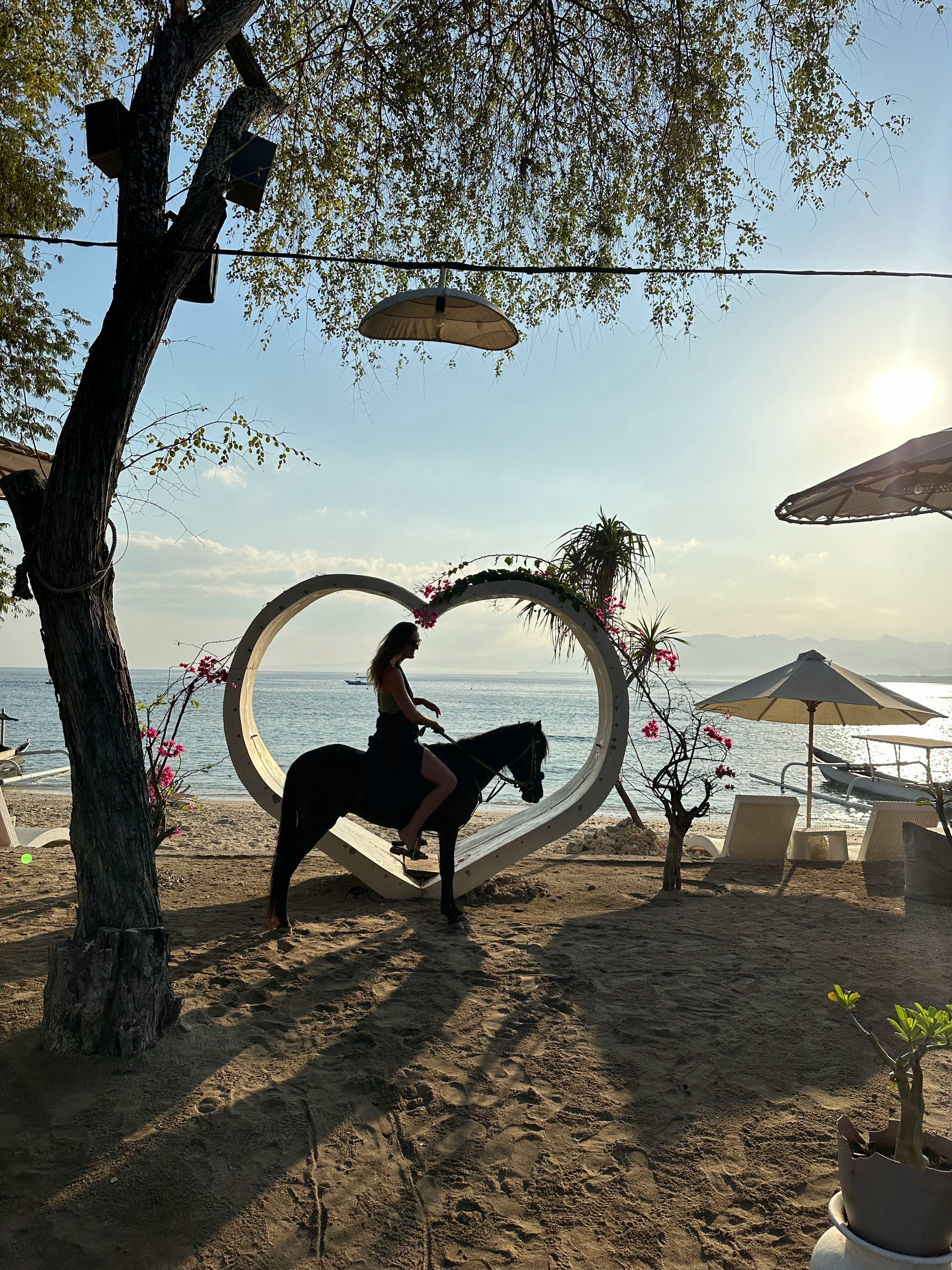Horse back riding tour on Gili Air at sunrise with ocean views and soft morning light