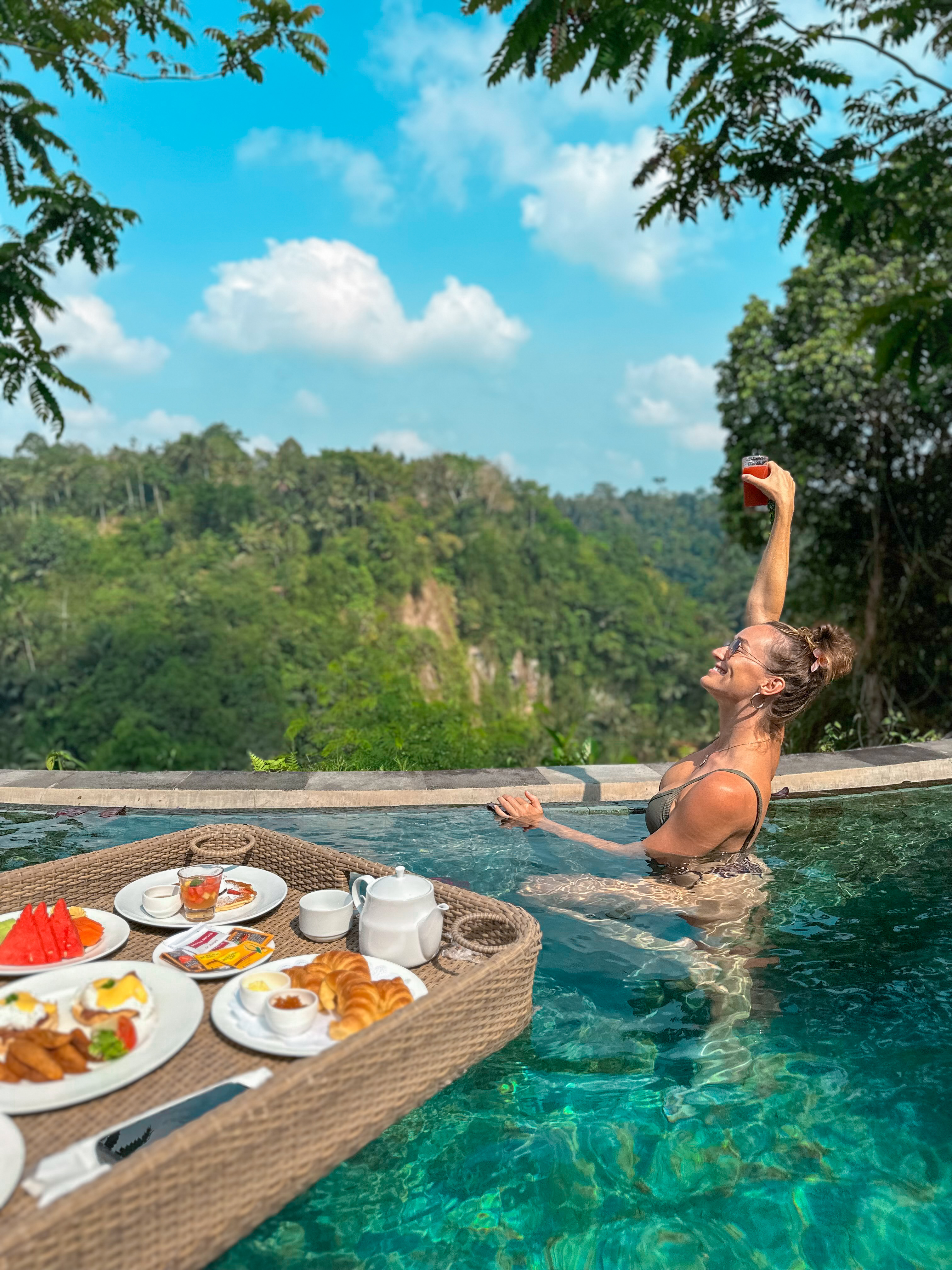 Carlijn de Jong enjoying breakfast in a jungle pool during a luxury hotel experience in Ubud Bali Indonesia
