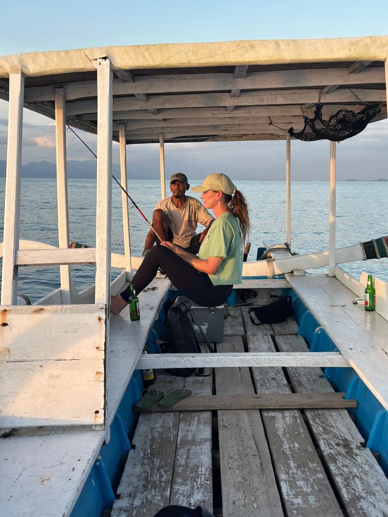 Travelers sitting on a small boat during an island-hopping trip in Lombok