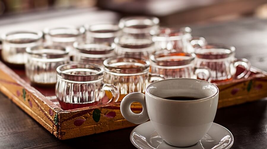 Coffee tasting setup with cups and glasses in Munduk, Bali