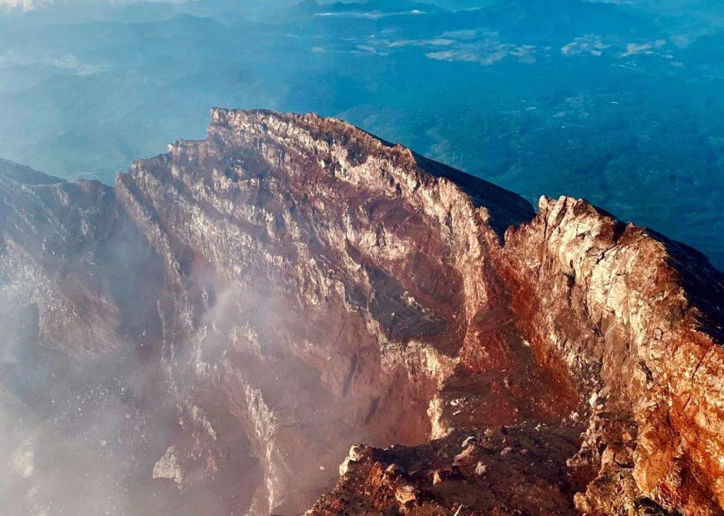 Aerial view of Mount Agung crater and volcanic rim
