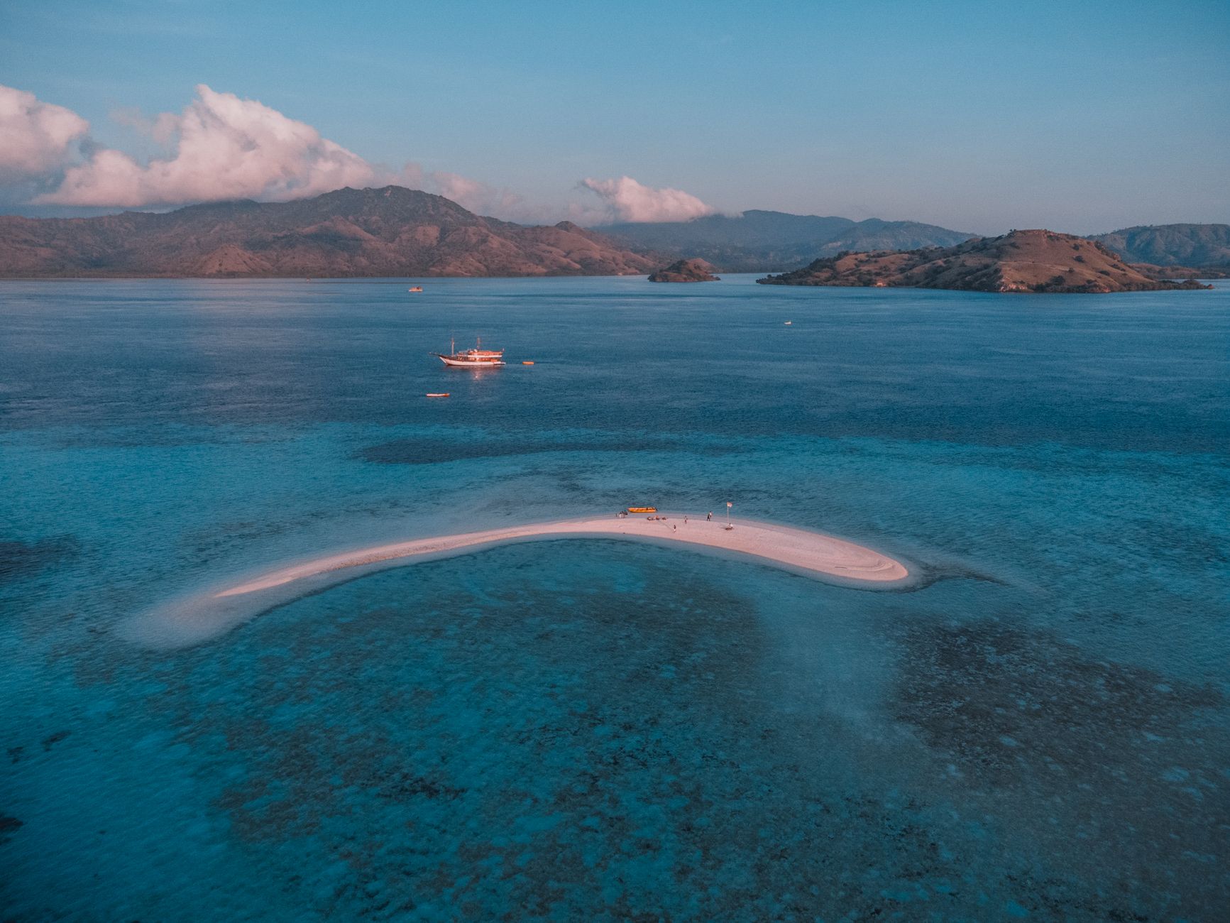 Aerial view of the narrow Taka Makassar sandbar surrounded by blue water in Komodo National Park.