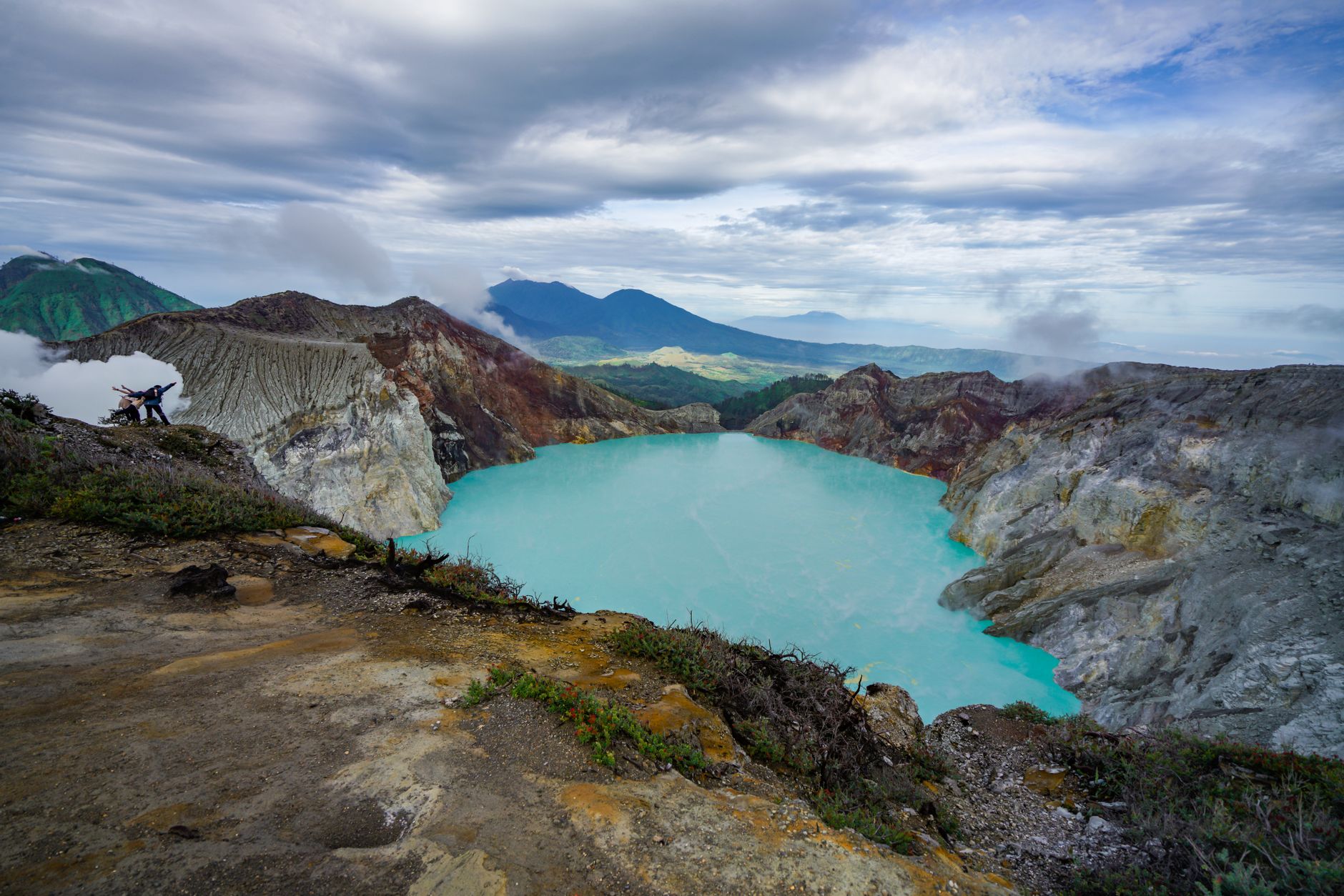 Sunrise view over Kawah Ijen crater lake and surrounding mountains in East Java