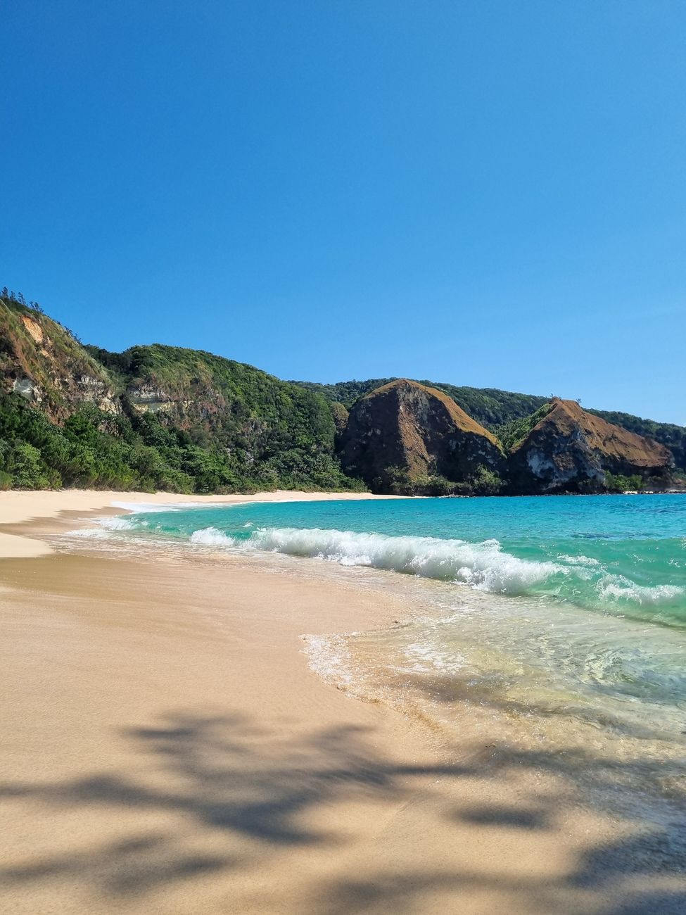 Turquoise beach and cliffs on the wild south coast of Sumba
