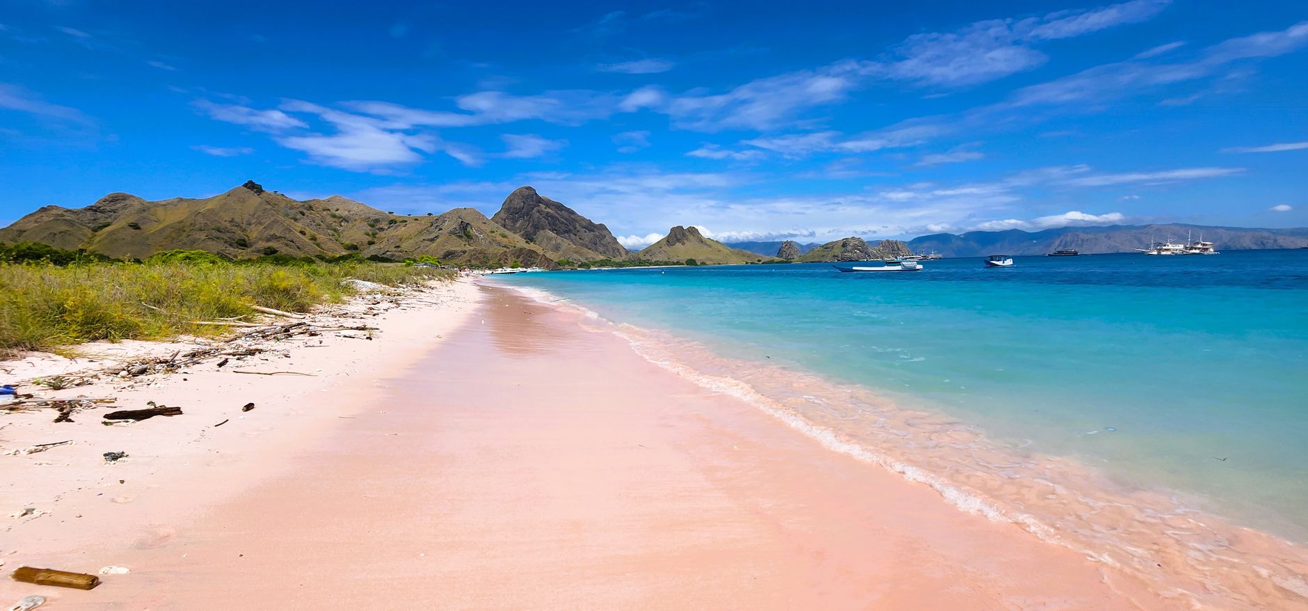 Pink sand and clear turquoise water along Pink Beach in Komodo National Park.