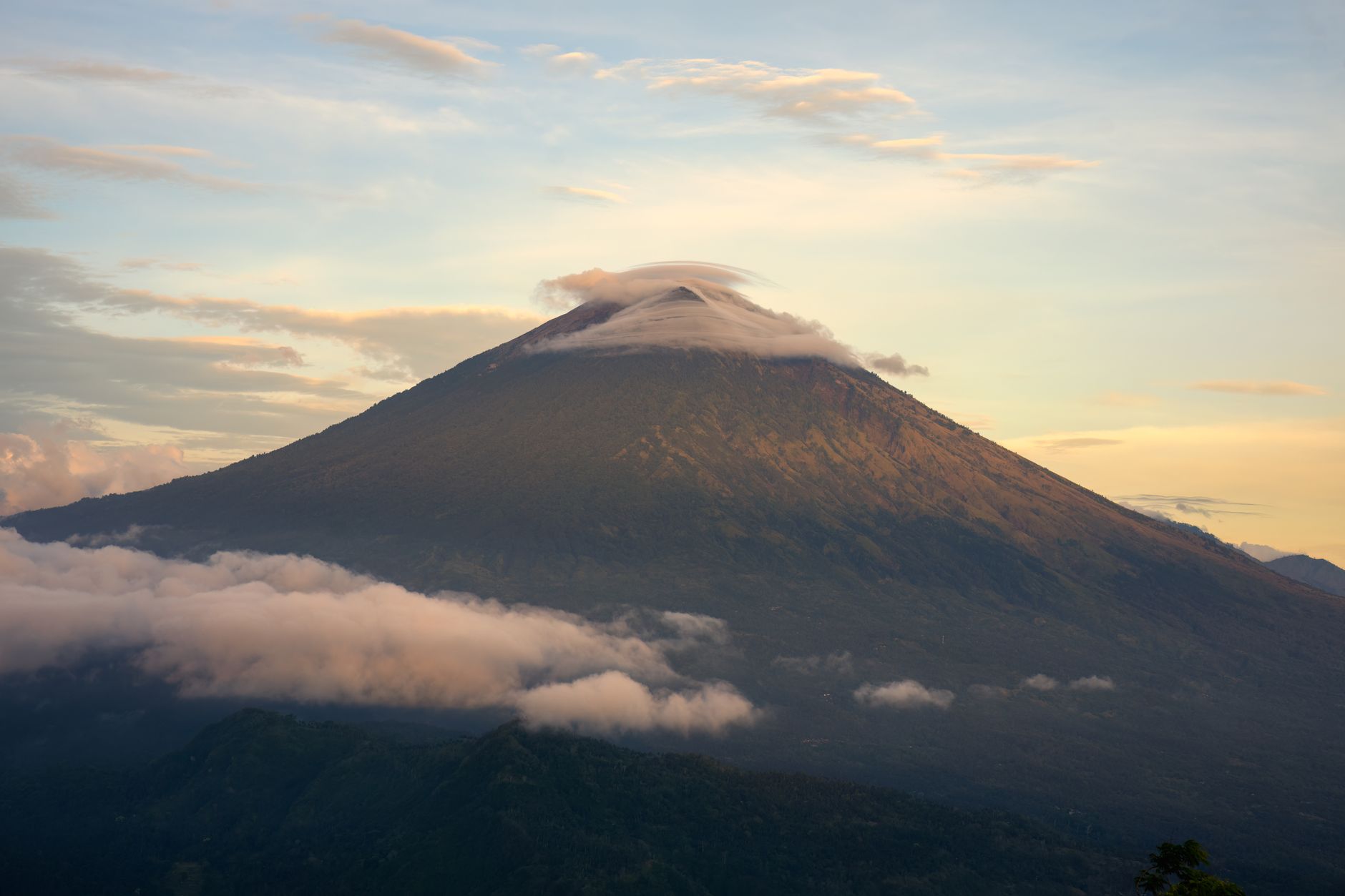 Mount Agung volcano rising above the clouds in Bali Indonesia
