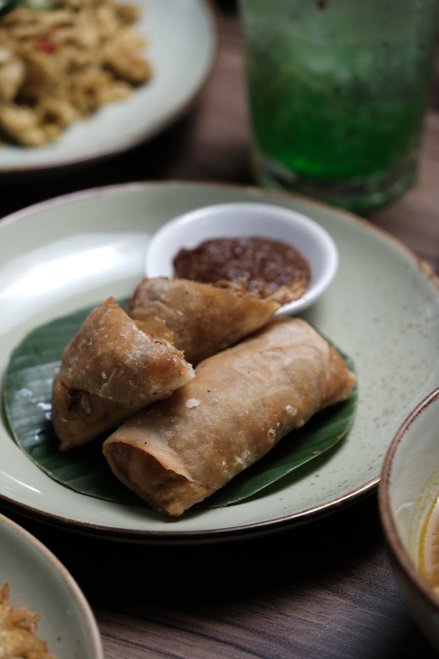 Lumpia Semarang spring rolls served with sauce on a plate