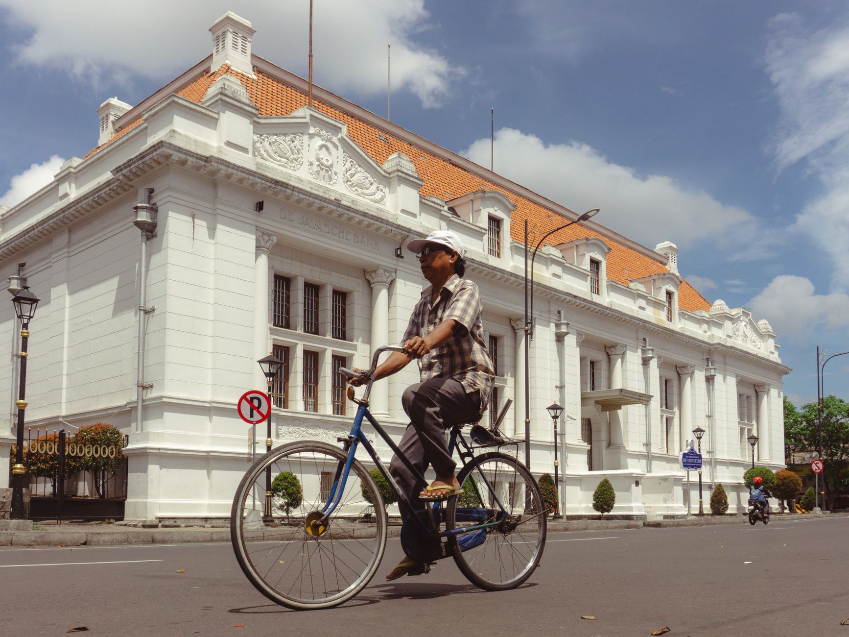 Older looking gentleman bikin in the centre of Surabaya. 