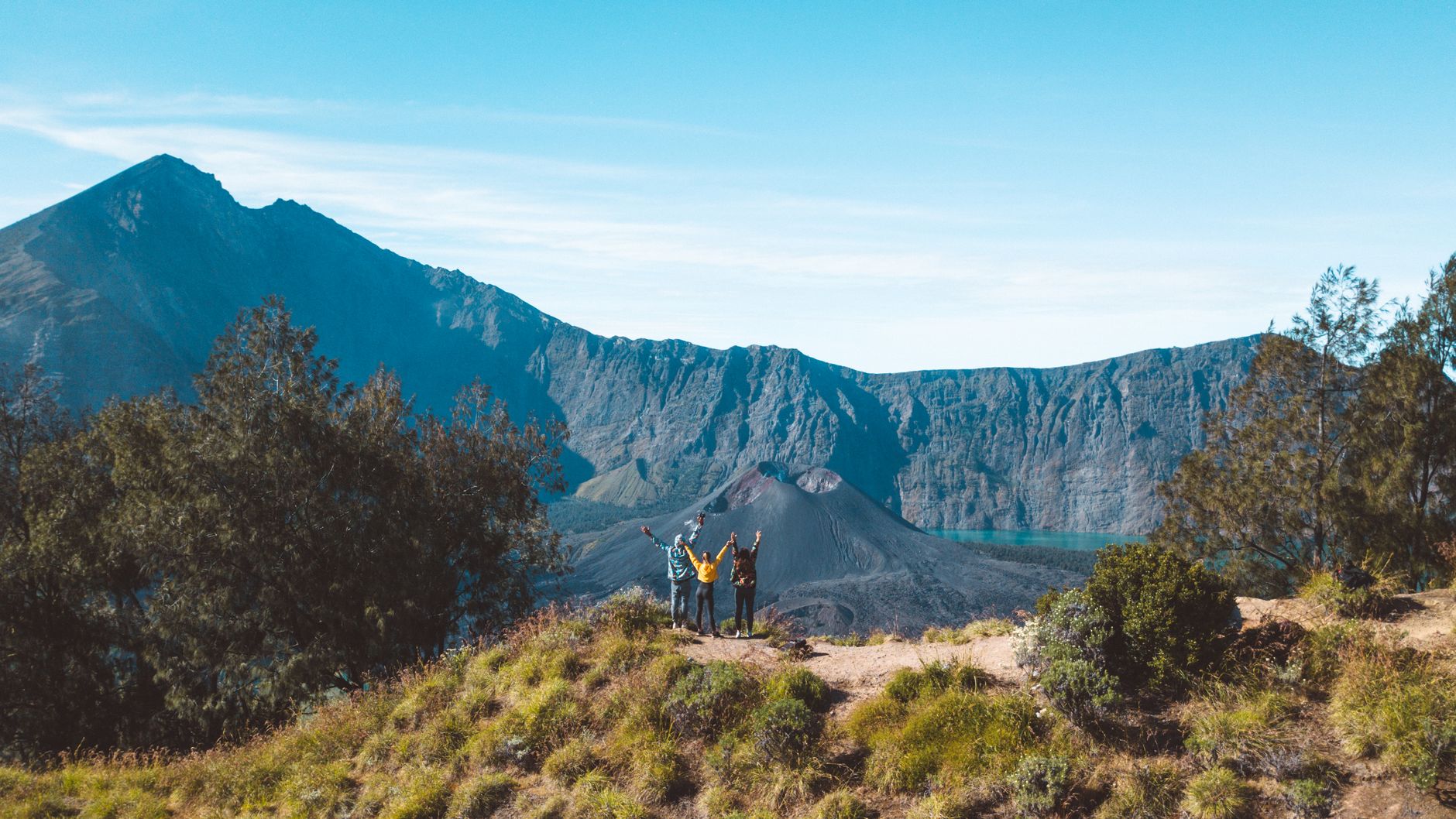 Hikers standing on the Mount Rinjani crater rim in Lombok

