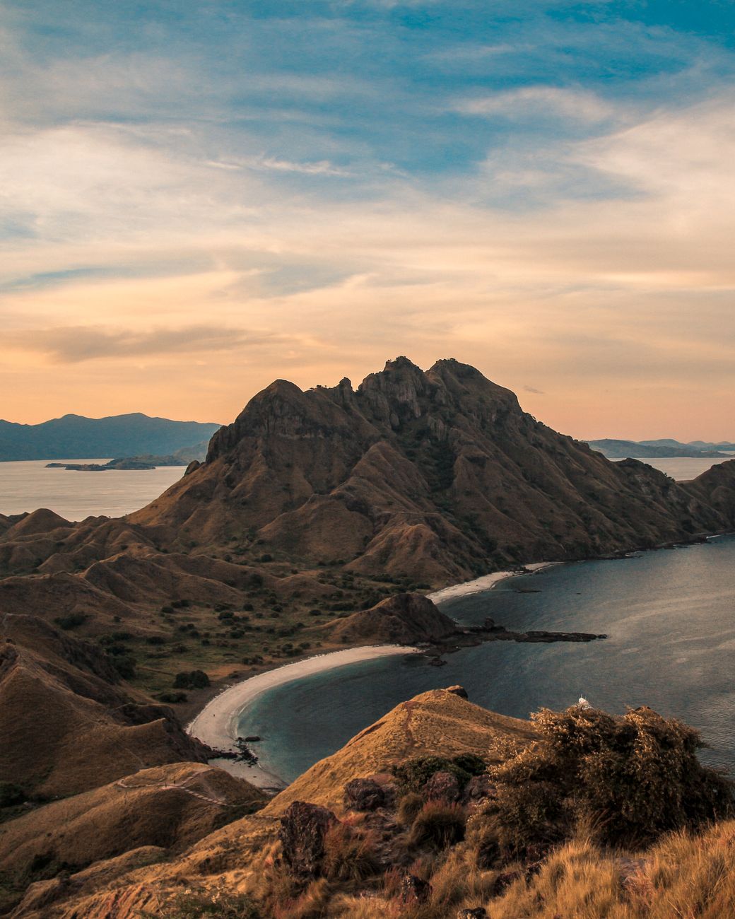 Famous Padar Island viewpoint overlooking curved bays and rugged hills in Komodo National Park.