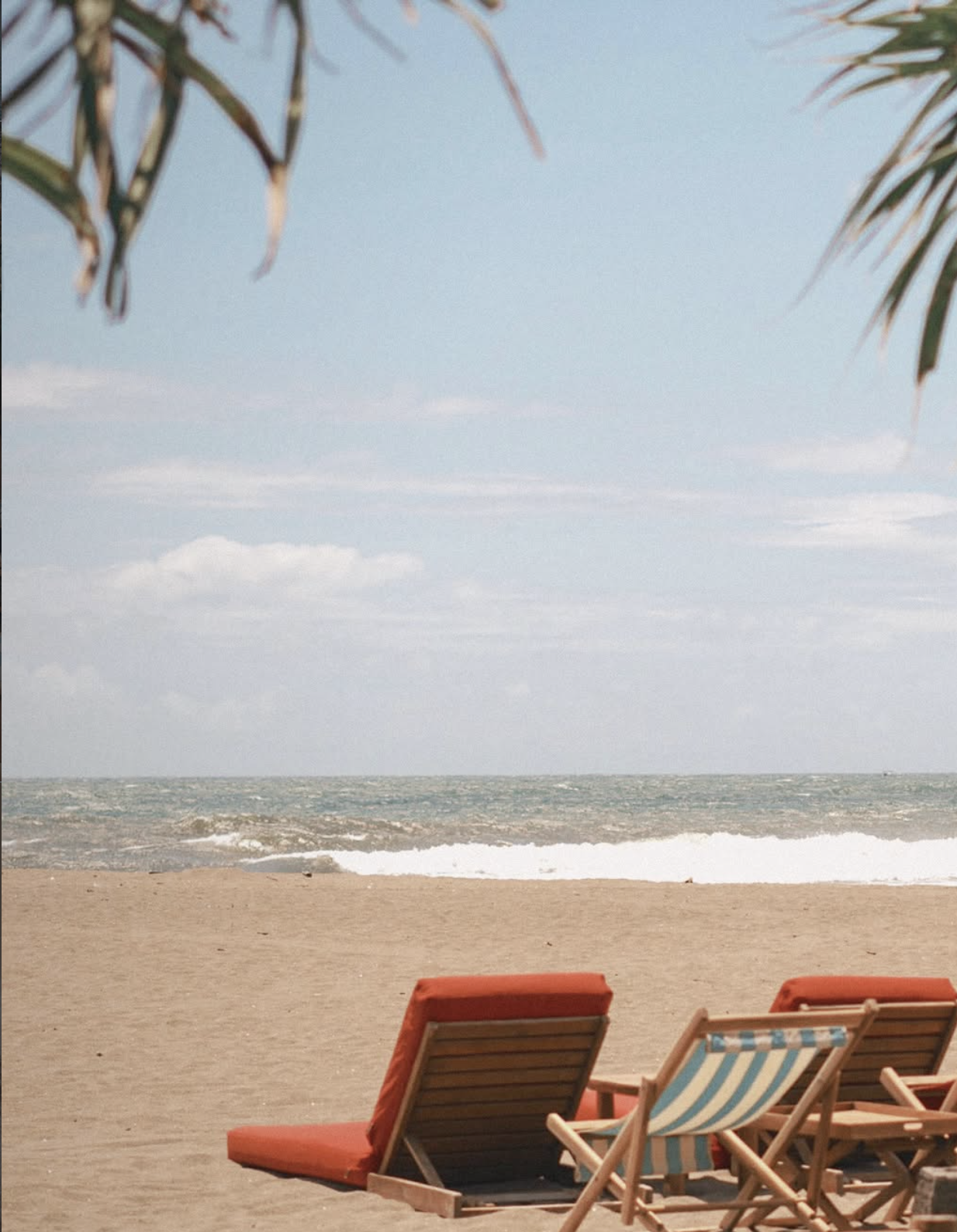 Sun loungers on Berawa Beach at sunset in Canggu, Bali