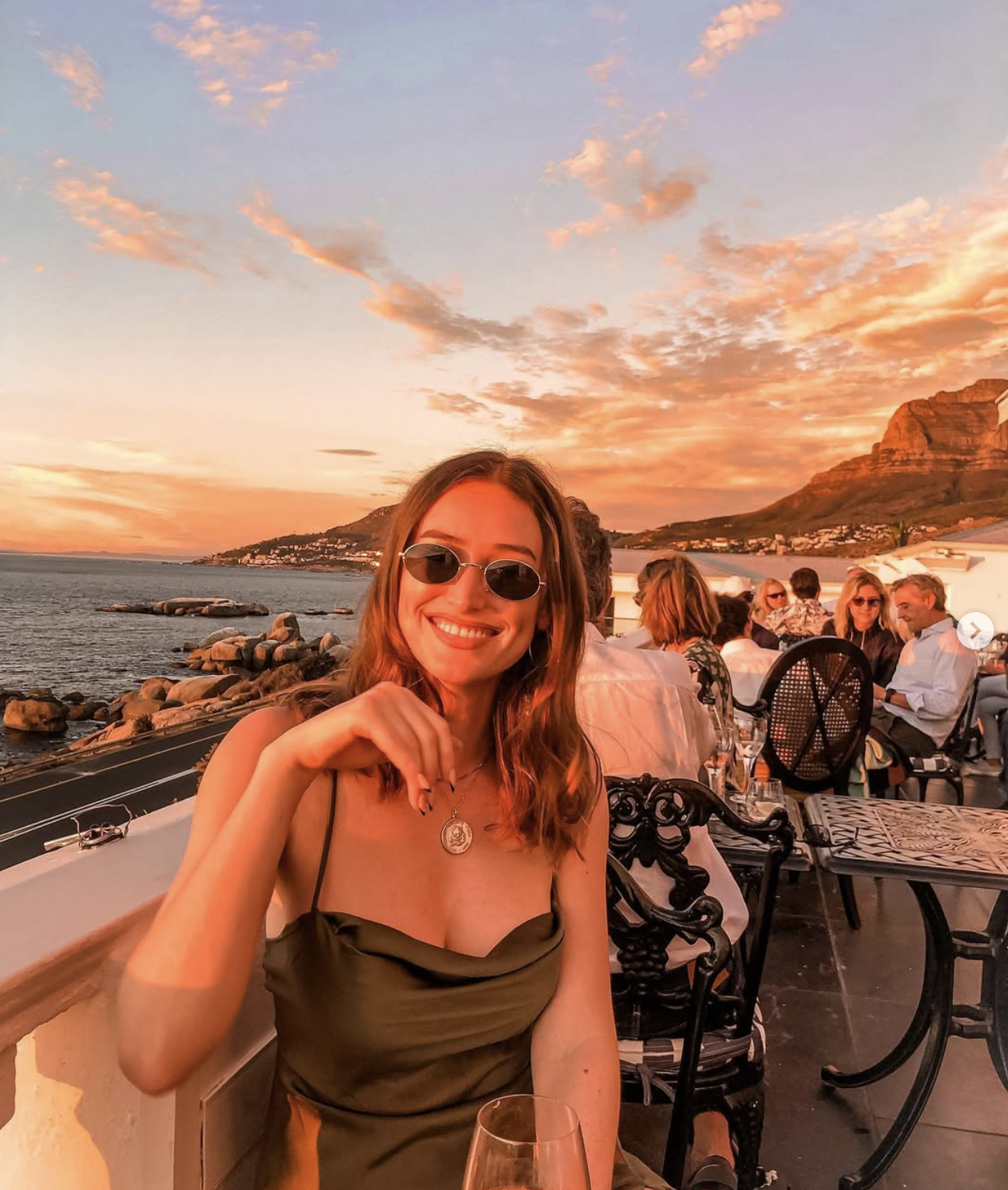 Carlijn at a sunset dinner overlooking the ocean in Cape Town