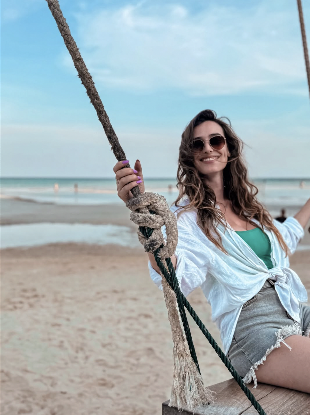Carlijn sitting on a beach swing at Pantai Bobby in Karimunjawa