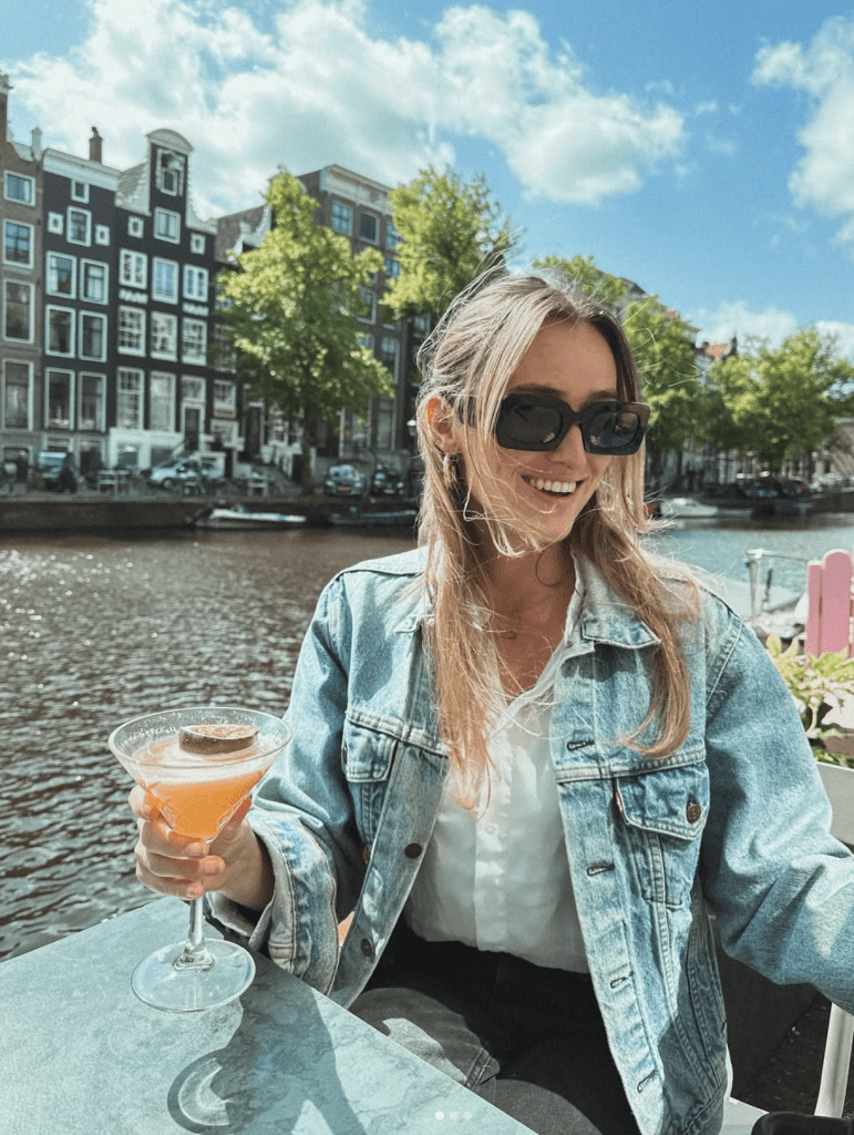 Carlijn de Jong smiling by an Amsterdam canal while reflecting on the future of Keep Up With Car