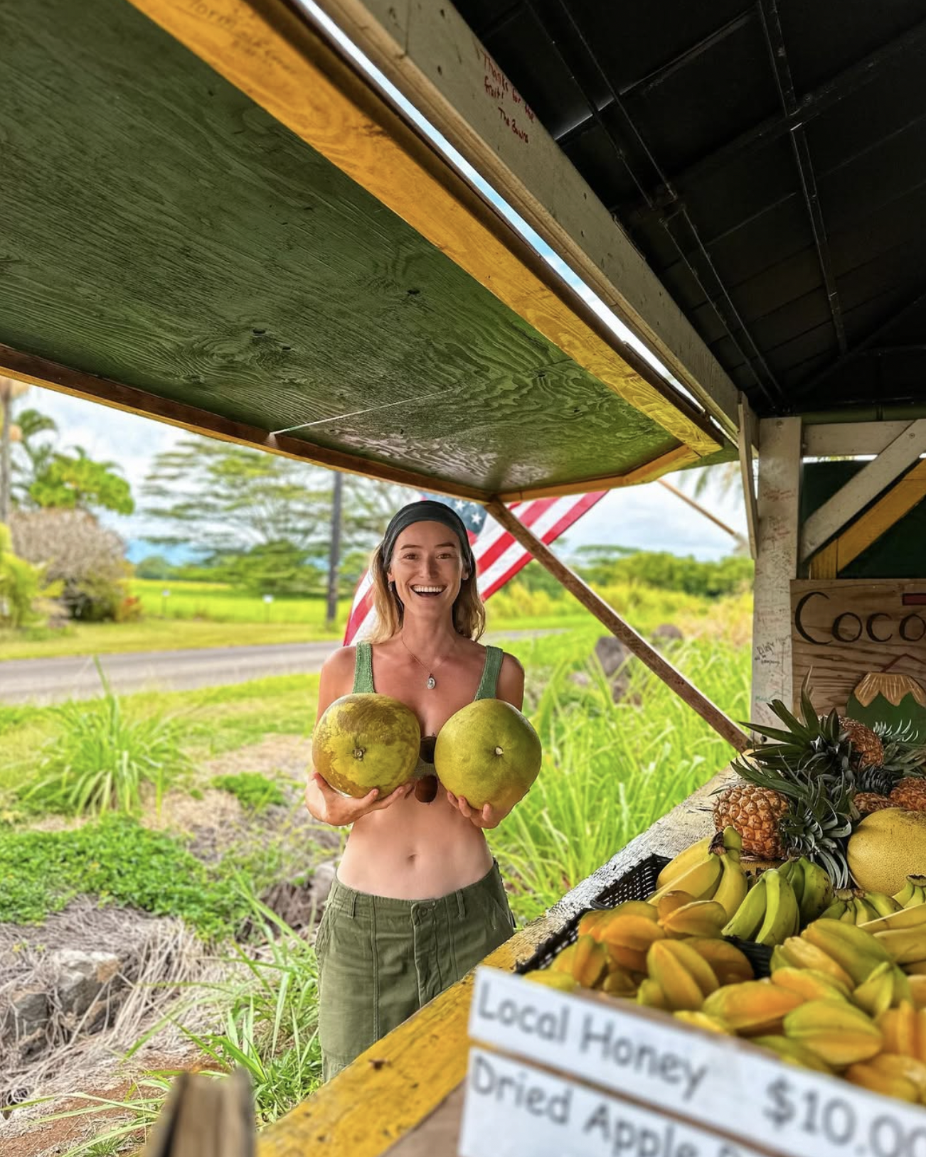 Carlijn holding coconuts at a local fruit stand in Kauai, Hawaii