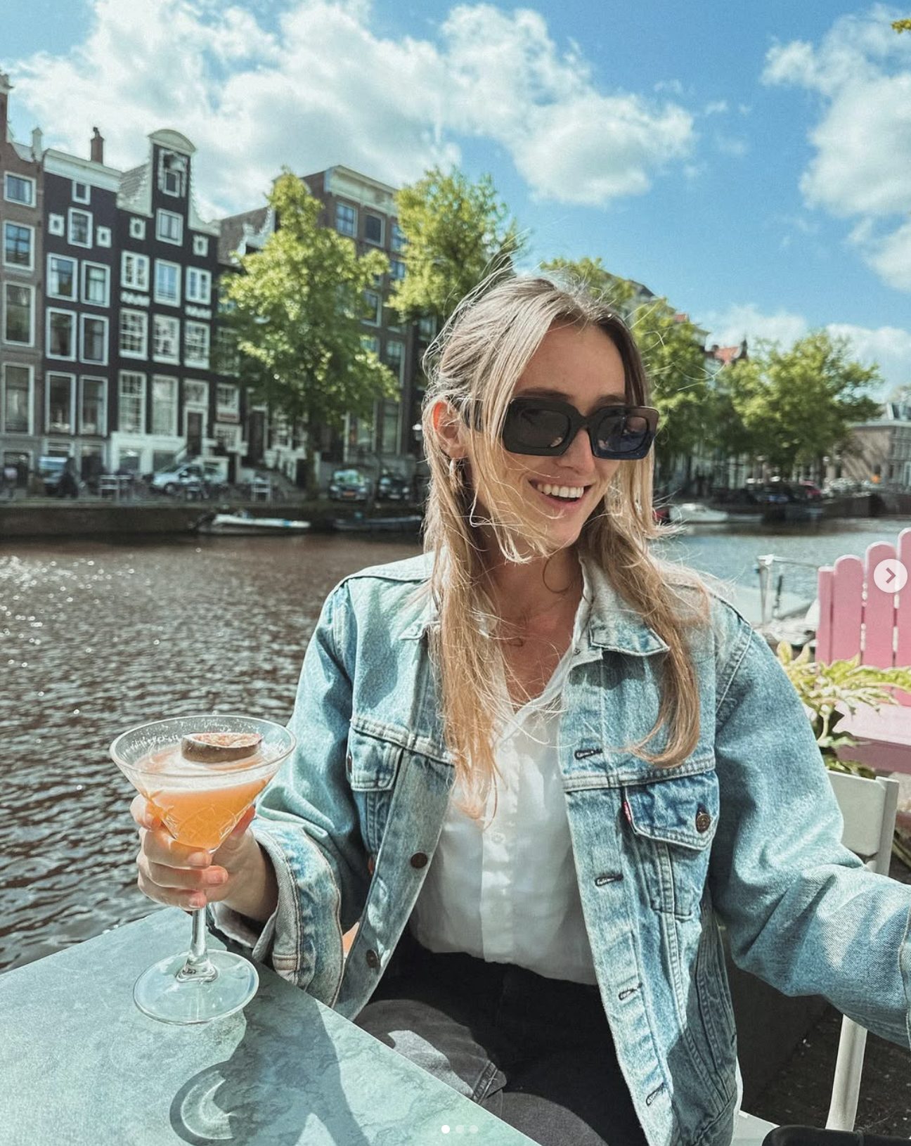 Carlijn having a drink by the canals in Amsterdam, Netherlands