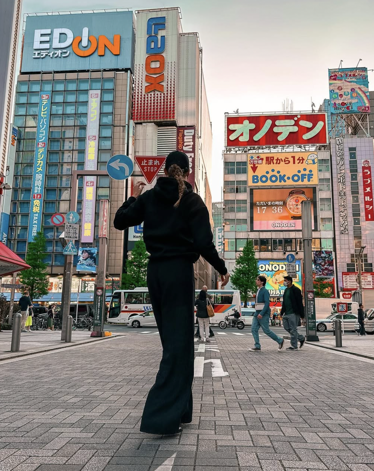 Carlijn walking through Akihabara with colorful signs and shops in Tokyo